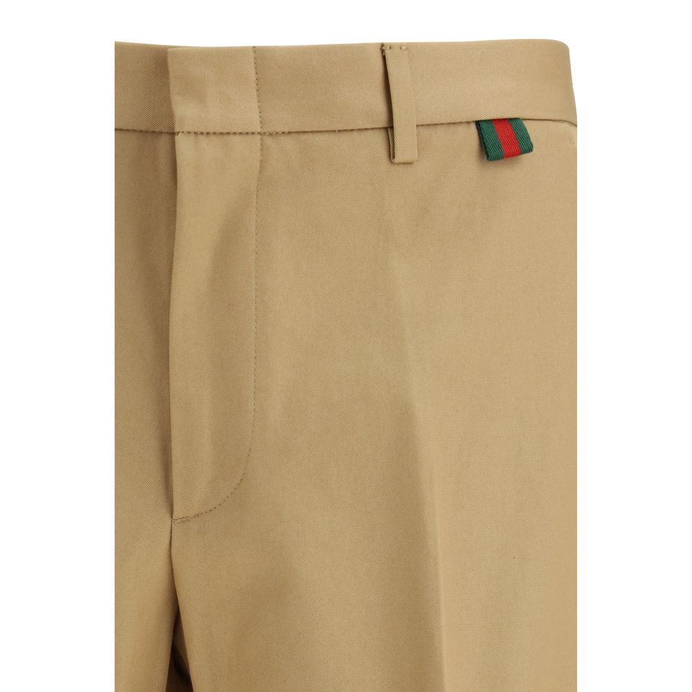 Trousers by Gucci for men in cotton beige features a sculptural silhouette, showcasing a sculptural regular-fit and long with a sophisticated for a sculptural finish.