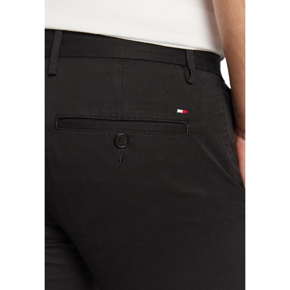 Trousers by Tommy Hilfiger for men in stretch cotton black features an sartorial silhouette, showcasing a precise skinny & slim and long with a sartorial for a refined look.