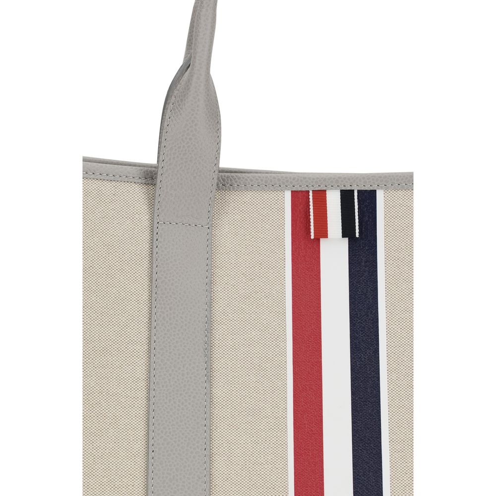 Large Tote Shoulder Bag by Thom Browne for men in cotton canvas & bos taurus calfskin leather black, gray, red, white & striped presents a versatile silhouette, showcasing a secure and versatile with versatile handle for a sophisticated look.