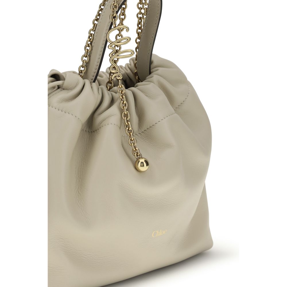 Shoulder Drawstring Bag by Chloé for women in nappa lambskin leather beige features a distinguished silhouette, showcasing a secure drawstring and distinguished with versatile shoulder-strap & handle for a distinguished finish.