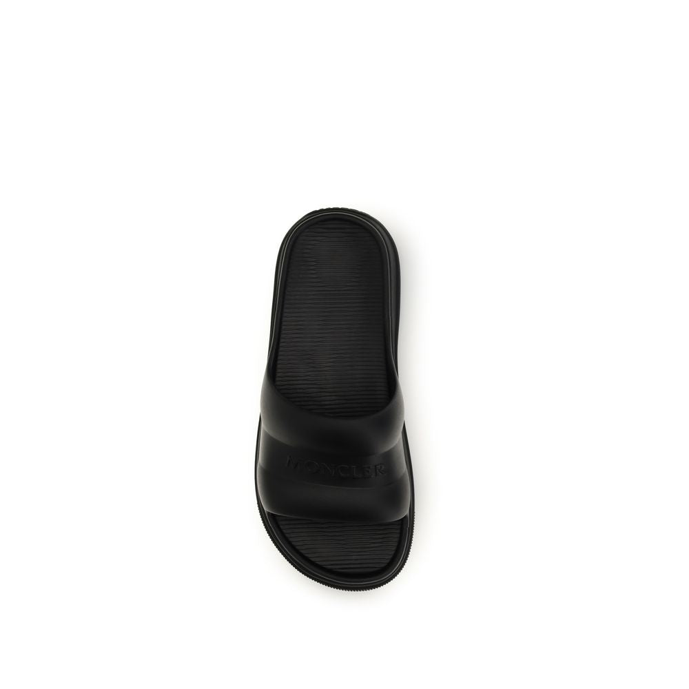 Slider Sandals by Moncler for women in rubber black features an exquisite silhouette, showcasing the exquisite Women's Rubber Slider Sandals with a and .