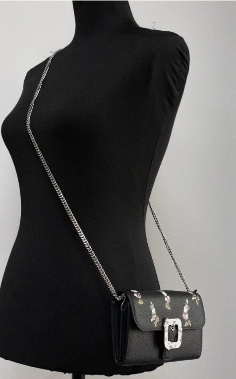 Small Crossbody Clutch Handbag by Kate Spade for women in faux patent leather black & silver features a signature silhouette, showcasing a secure snap & zipper and signature cardholder with versatile crossbody-strap & detachable-strap for a sophisticated look.