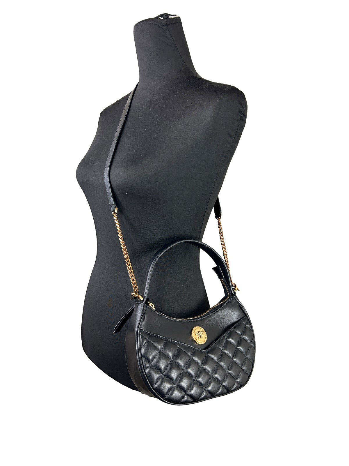 Quilted Crossbody Half Moon Handbag by Versace for women in leather black & gold features an multi-faceted design with a secure zipper, ample cardholder, and versatile crossbody-strap, shoulder-strap, adjustable-strap & detachable-strap for a multi-faceted finish.