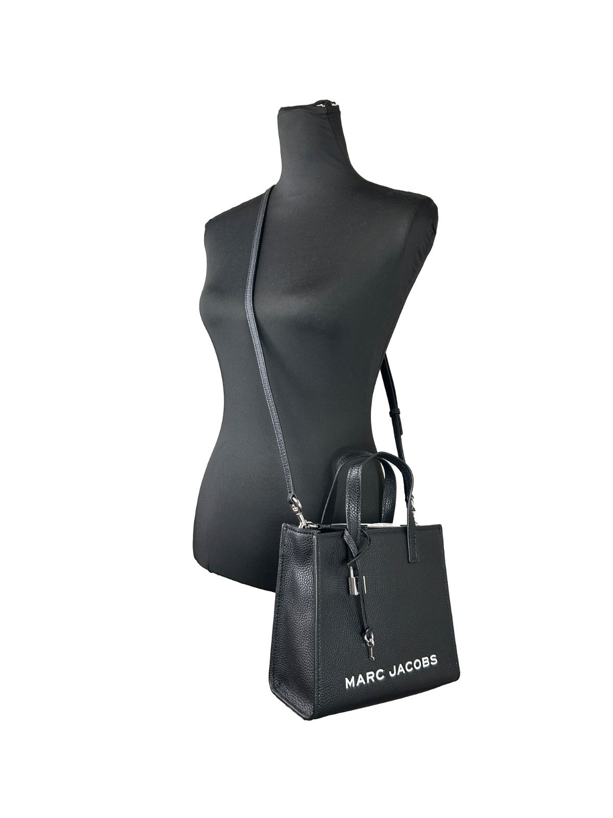 Mini Crossbody Tote Handbag by Marc Jacobs for women in faux patent leather black & silver features a transformative elegance silhouette, showcasing a secure zipper, organized , and versatile crossbody-strap, adjustable-strap & detachable-strap for a transformative elegance look.