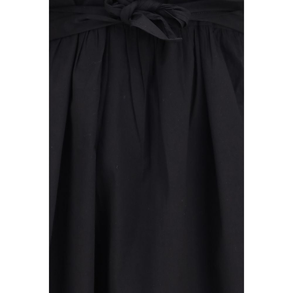 Dress by Ganni for women in stretch cotton black features a dramatic silhouette, showcasing an elegant and that flows into a dramatic midi.