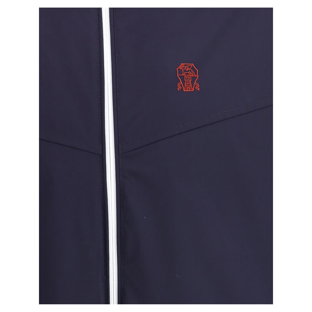 Hooded Windbreaker Jacket by Brunello Cucinelli for men in stretch polyamide blue presents a resilient silhouette, artfully detailed with a sophisticated and functional water-resistant, pockets, hooded & windproof for a resilient finish.