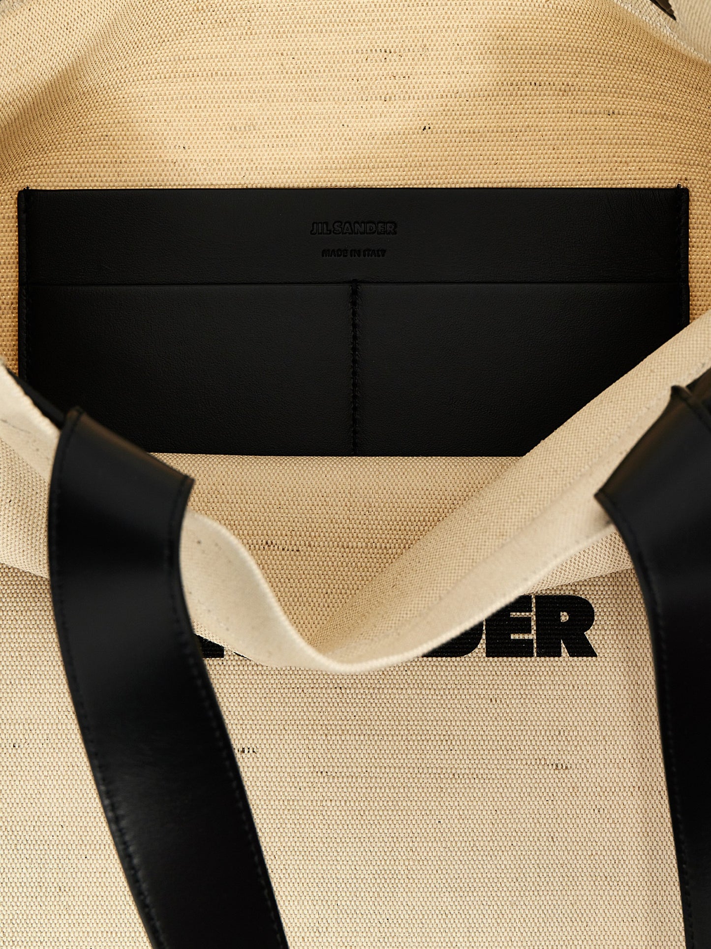 Medium Shopper Tote Bag by Jil Sander for men in leather virgin wool & nylon bicolour, black & white features a jet-set sophisticated Leather Virgin Wool & Nylon Medium Shopper Tote Bag design with a secure , ample , and versatile for a jet-set sophisticated finish.