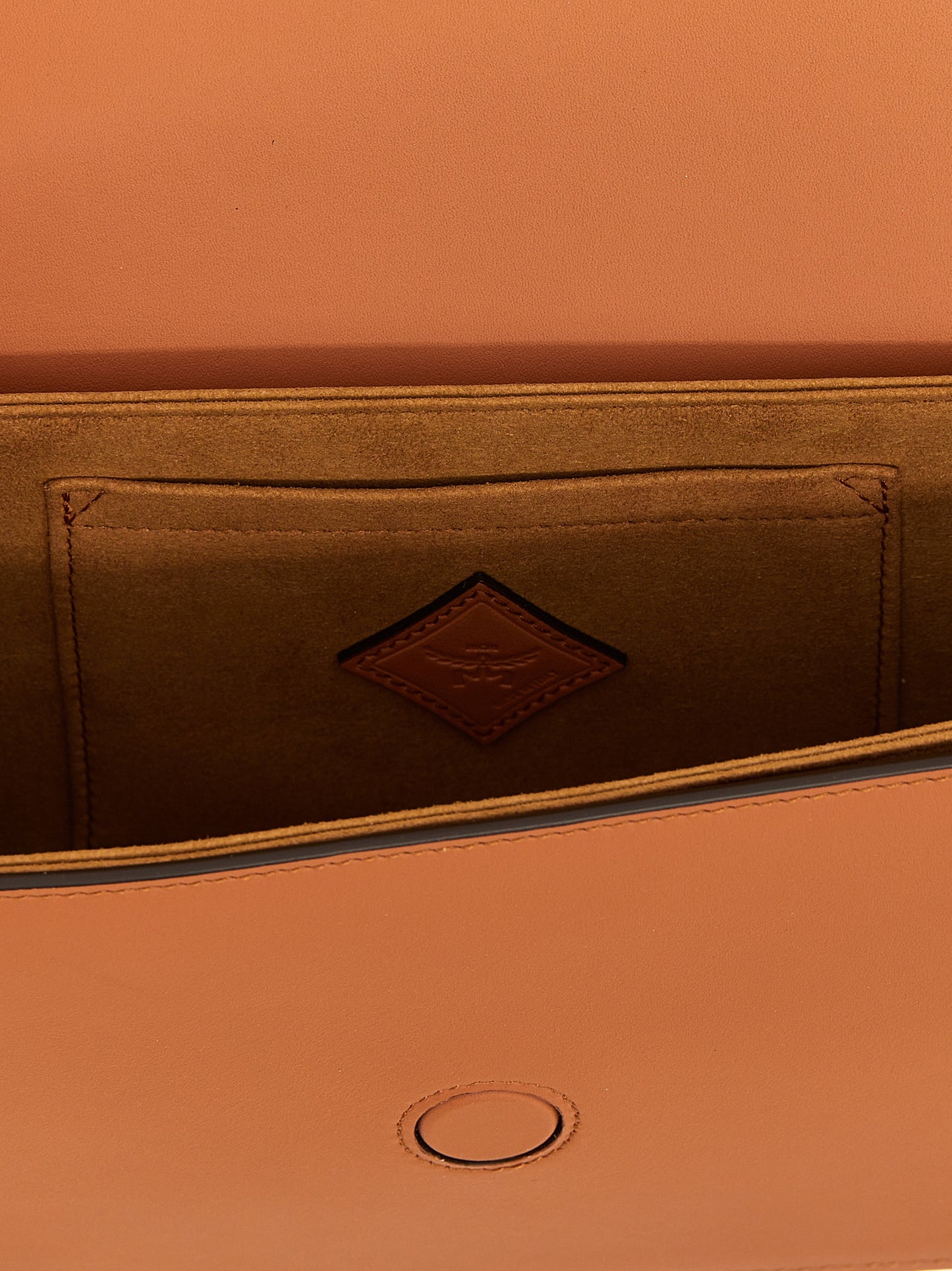 Crossbody Flap Handbag by MCM for women in calfskin leather brown features a transformative elegance silhouette, showcasing a secure flap & magnetic, organized , and versatile crossbody-strap, shoulder-strap & adjustable-strap for a transformative elegance look.
