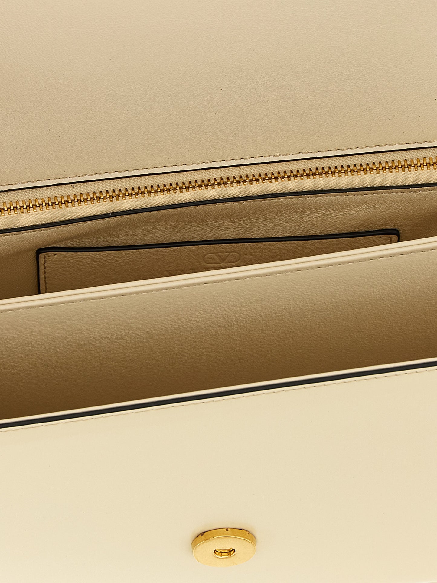 Shoulder Flap Bag by Valentino Garavani for women in calfskin leather white & signature presents a statuesque silhouette, showcasing a secure flap & magnetic and statuesque with versatile shoulder-strap & handle for a sophisticated look.