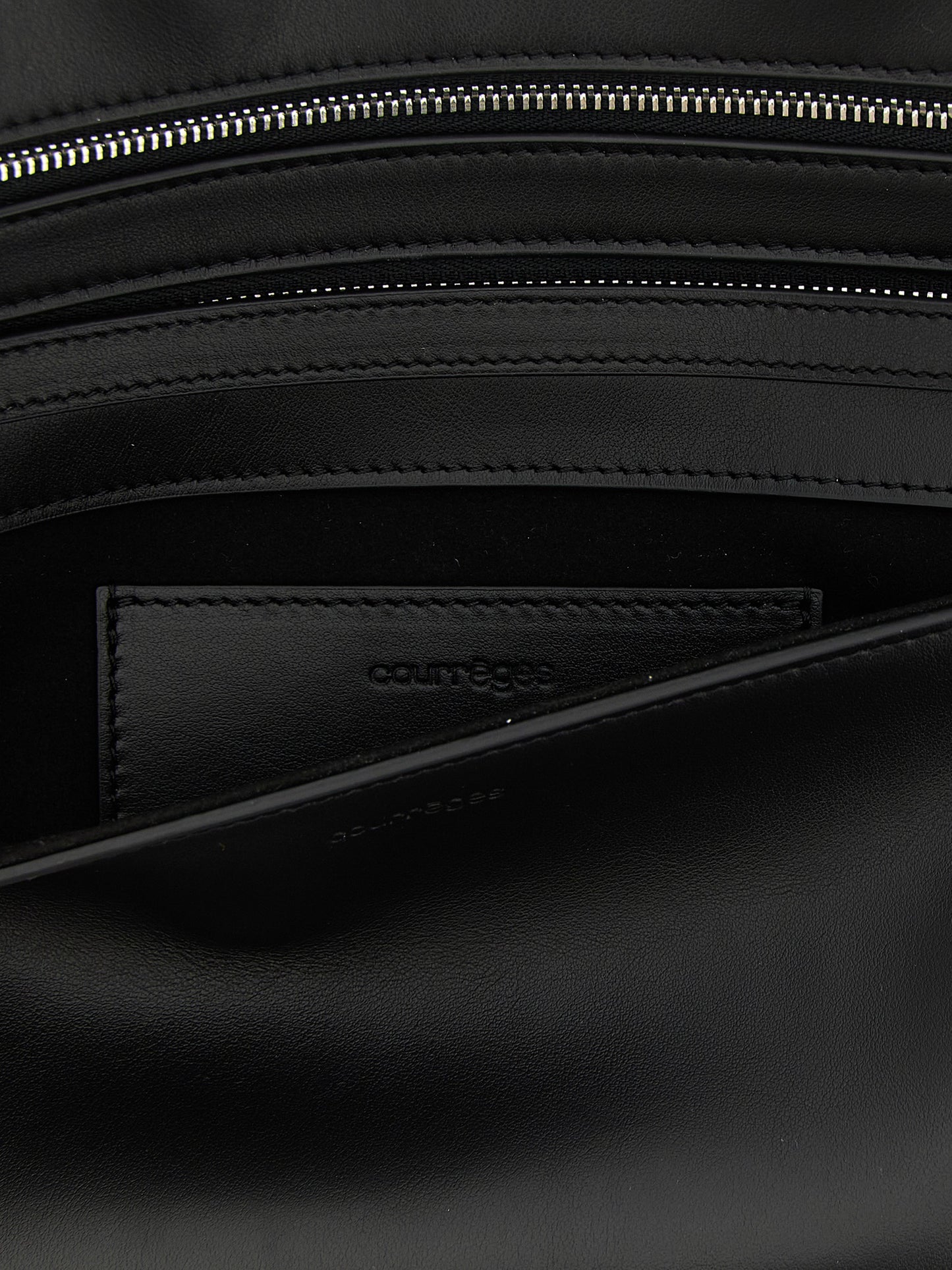 Shoulder Flap Clutch Handbag by Courrèges for women in denim cotton & acetate black features a sculptural silhouette with a secure flap, zipper & magnetic, organized , and versatile shoulder-strap, wristlet, adjustable-strap & handle for a sculptural finish.