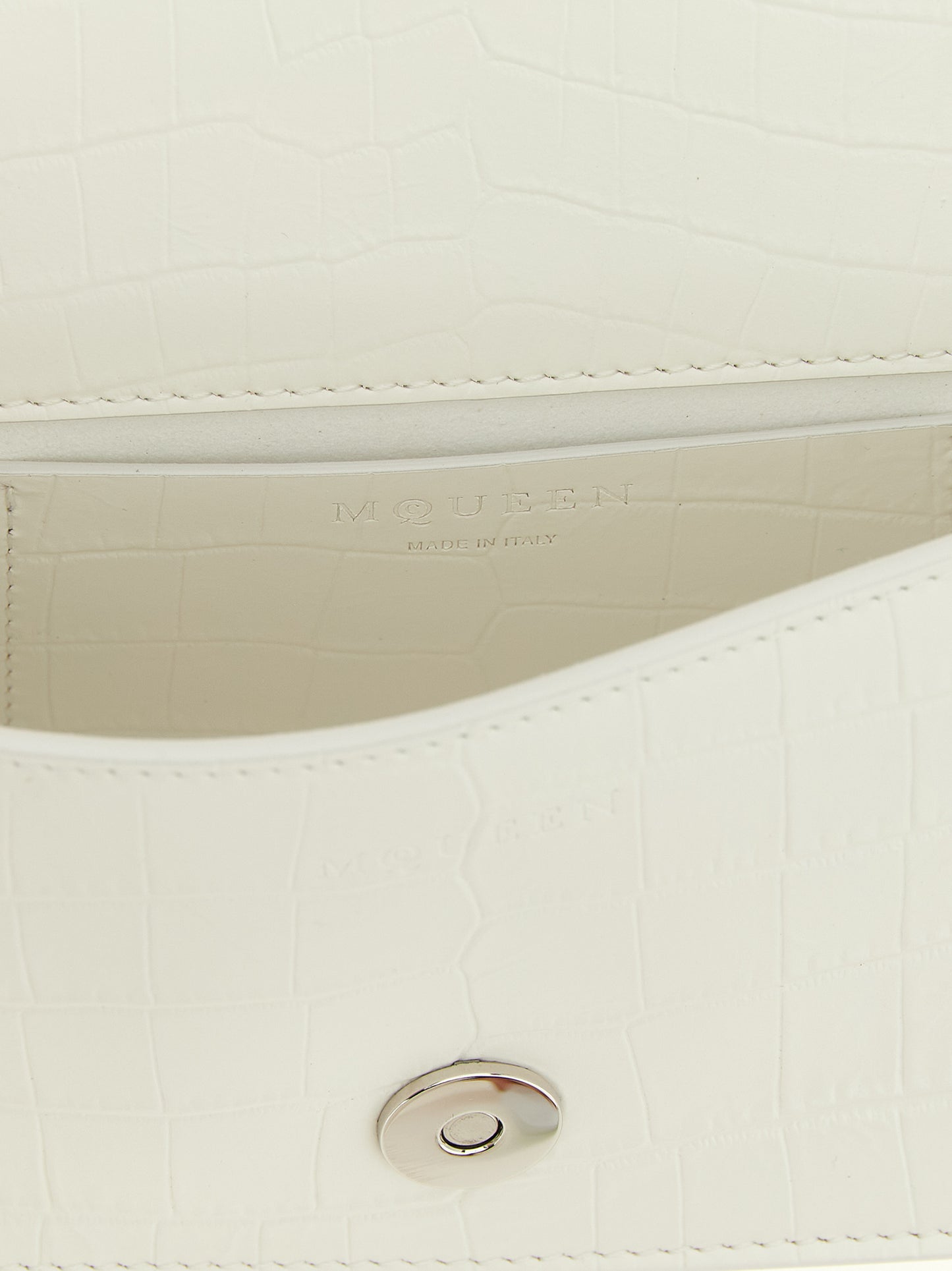 Mini Shoulder Flap Bag by Alexander McQueen for women in calfskin leather white, signature & print features a statuesque silhouette, showcasing a secure flap & magnetic and statuesque with versatile shoulder-strap, adjustable-strap & handle for a statuesque finish.