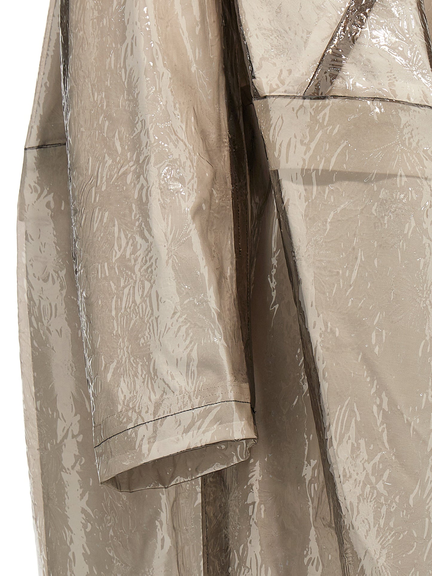 Trench Coat by Comme Des Garçons for women in polyethylene & polyurethane gray features an dramatic silhouette, perfectly showcasing the elegant and sophisticated pockets for a truly dramatic aesthetic.