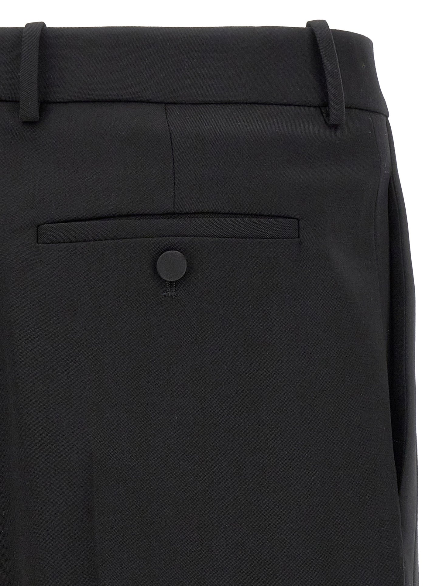 Trousers by Saint Laurent for men in satin wool black features a sculptural silhouette, showcasing a sculptural and long with a sophisticated high rise for a sculptural finish.
