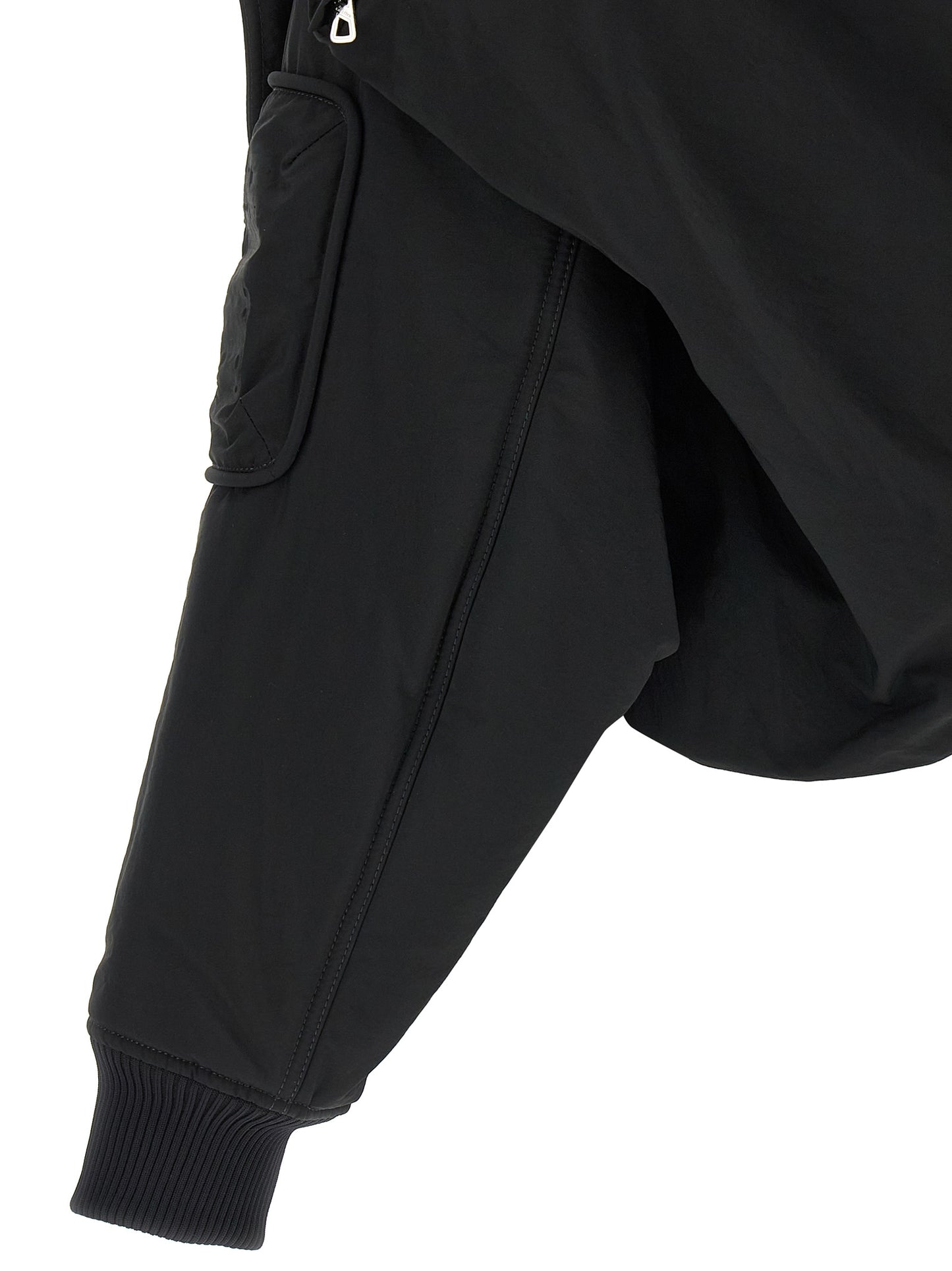 This Hooded Bomber Jacket by Jean Paul Gaultier for women in polyester polyurethane polyethylene black exhibits a edgy silhouette, meticulously detailed with functional pockets, hooded & insulated and a edgy for a edgy finish.