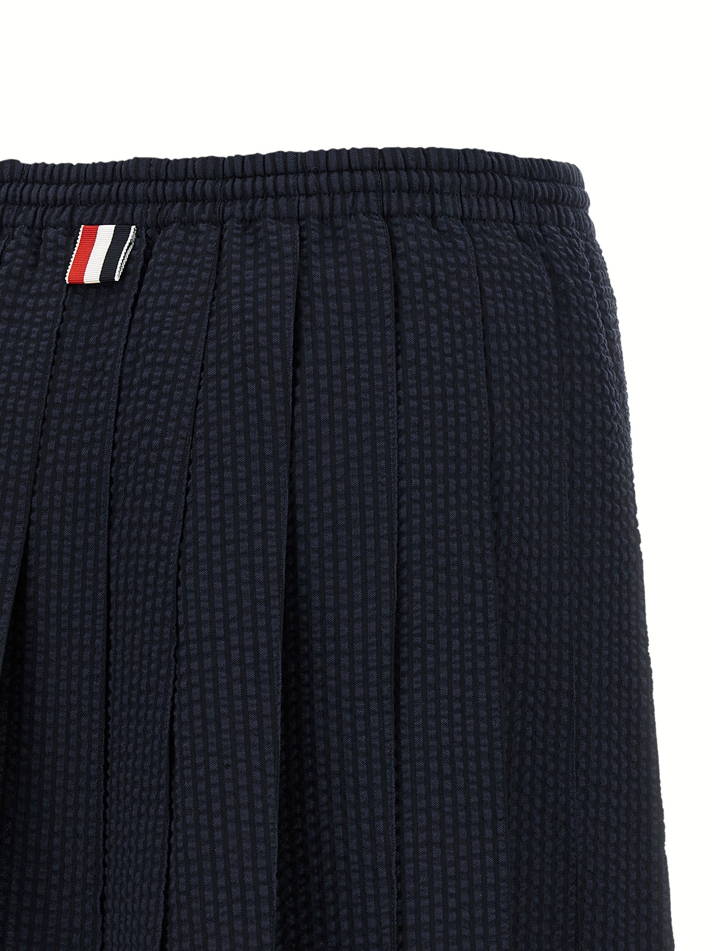 Skirt by Thom Browne for women in wool blue & striped features an relaxed-yet-refined silhouette that elegantly showcases the Women's Pleated Flared Wool Mini Long Skirt design and sophisticated mini long.
