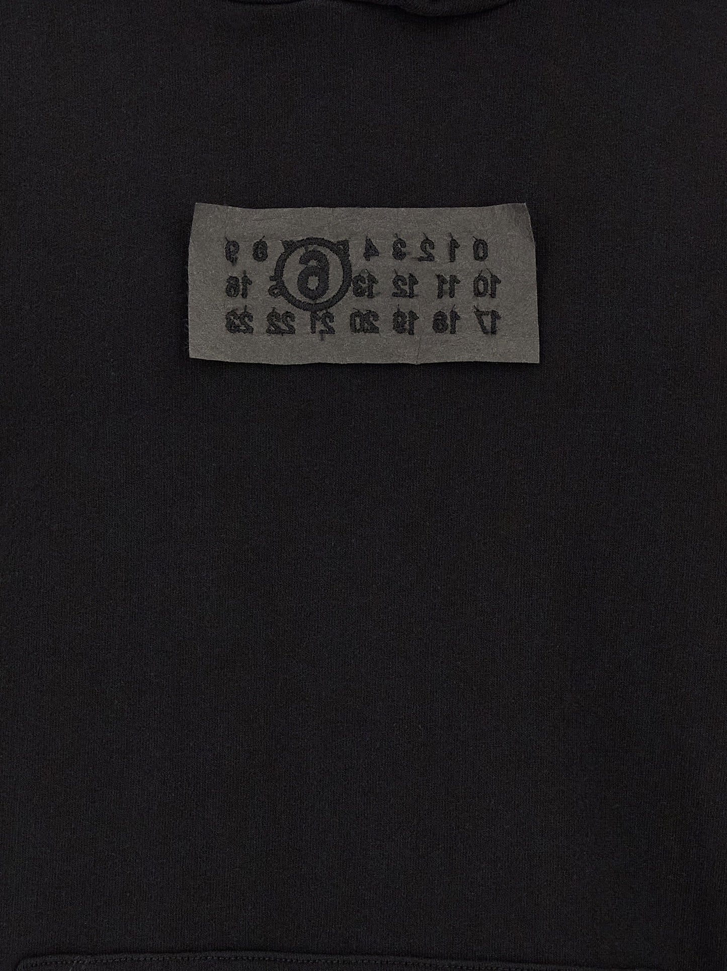 Sweatshirt Hoodie by MM6 Maison Margiela for men in cotton black features a slouchy chic silhouette, detailed with a slouchy chic and a signature for an elevated aesthetic.