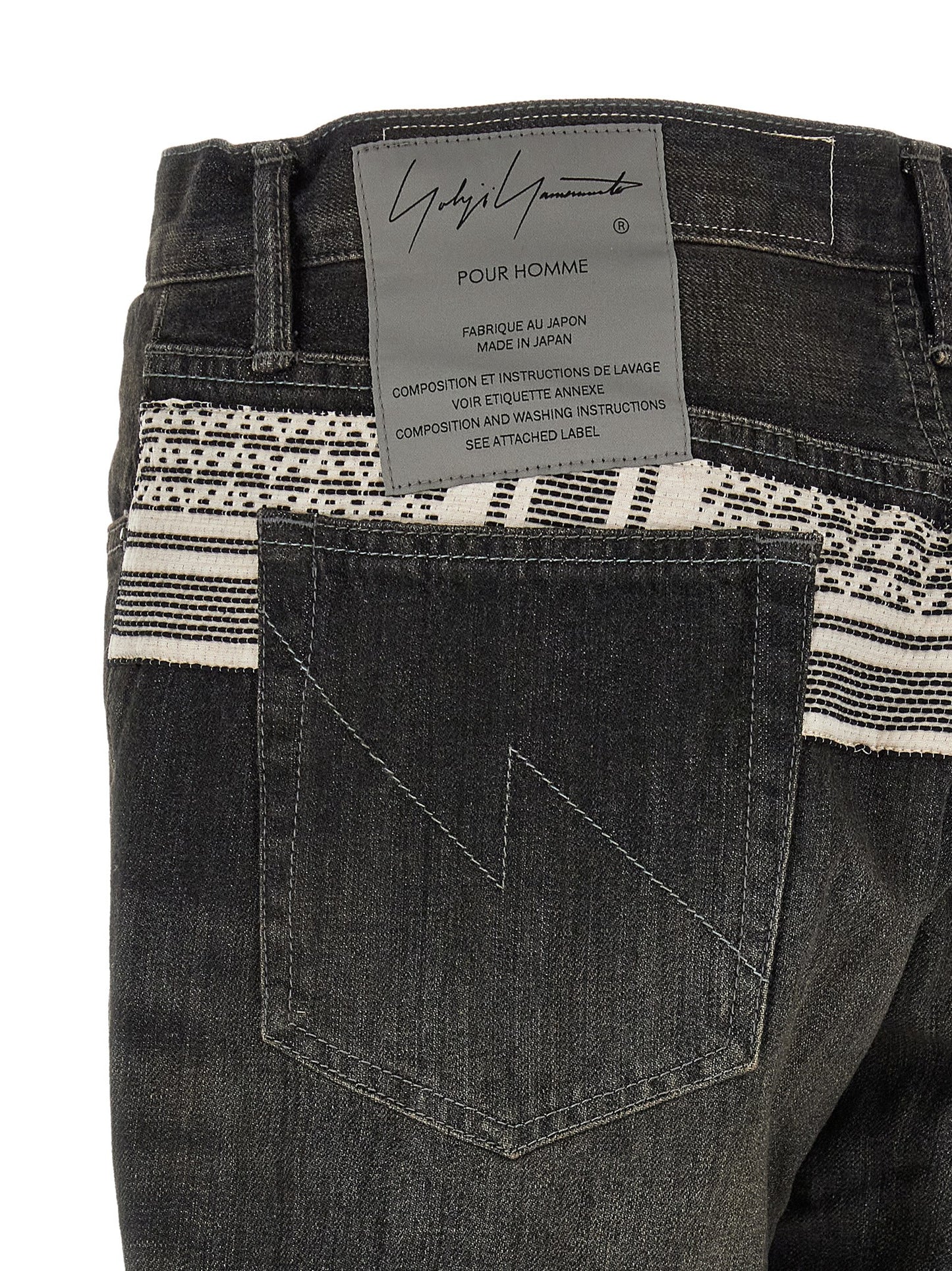 Jeans by Yohji Yamamoto for men in denim cotton black & jacquard presents a refined pantology silhouette, artfully defined by a refined pantology tapered-leg, long, and a sophisticated mid rise.
