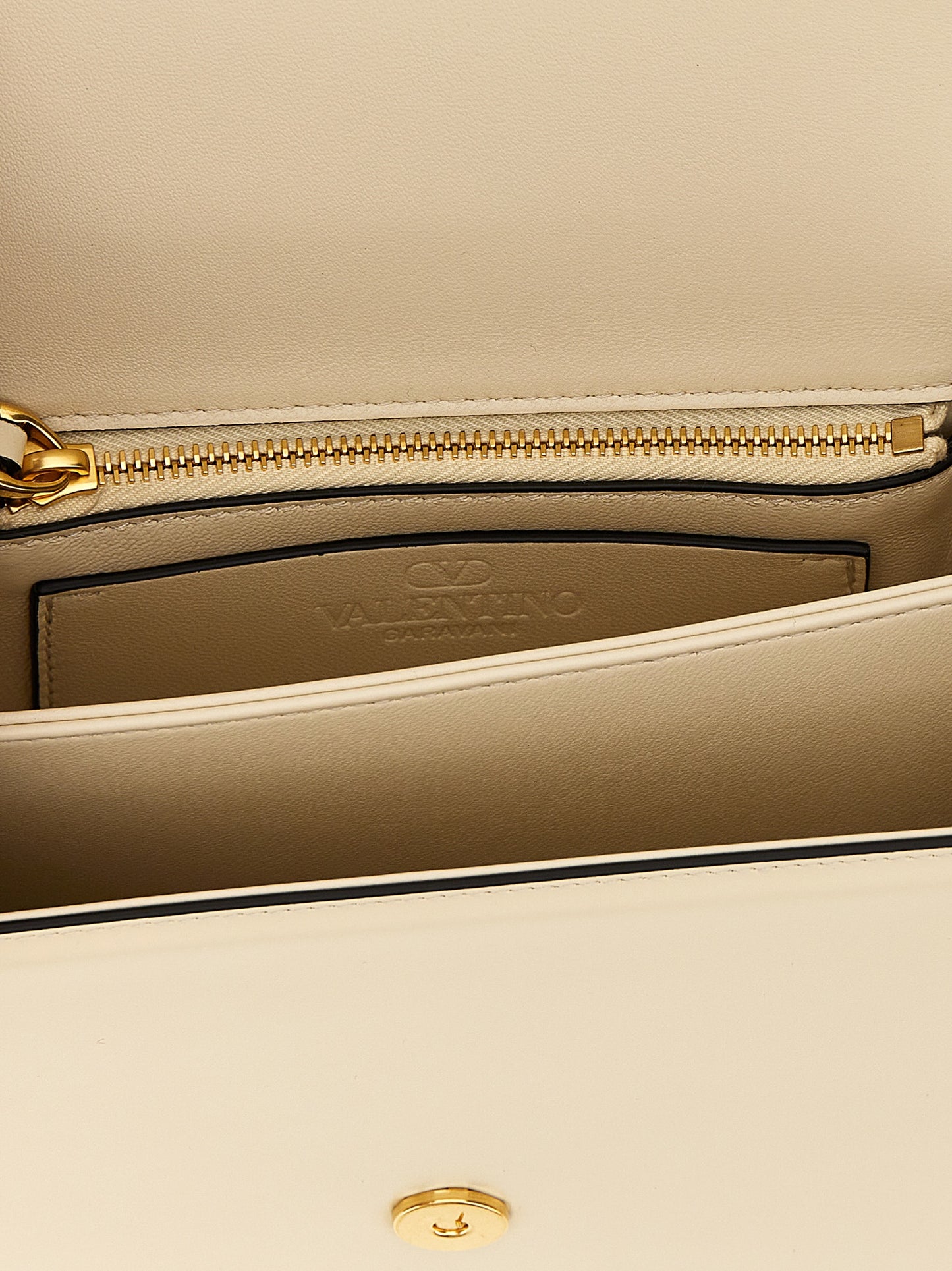 2-in-1 Shoulder & Crossbody Flap Bag by Valentino Garavani for women in calfskin leather white & signature features a effortless chic silhouette with a secure flap & magnetic, ample , and versatile crossbody-strap & shoulder-strap for a effortless chic finish.
