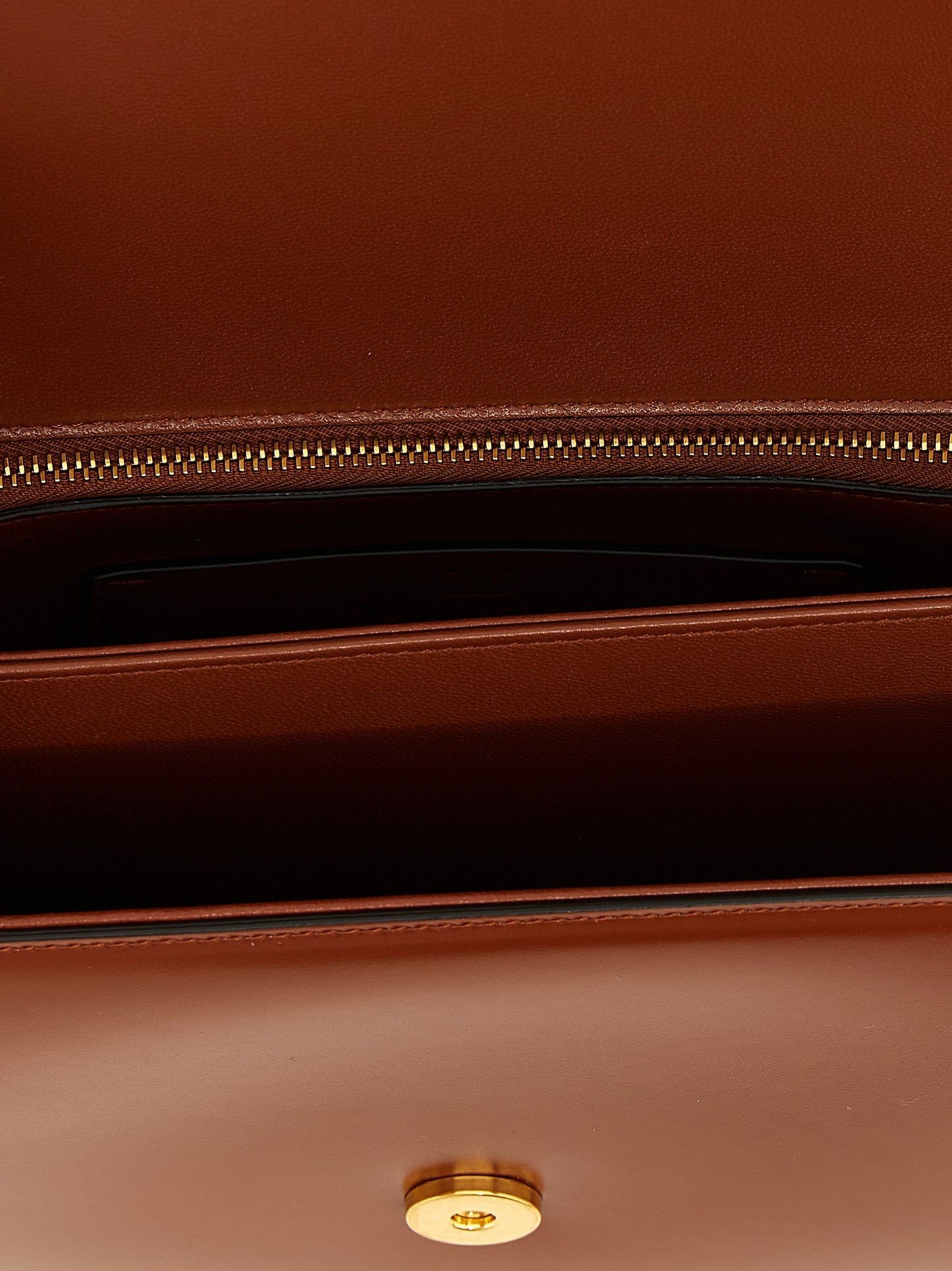 Shoulder Flap Bag by Valentino Garavani for women in nappa calfskin leather brown & signature features a effortless sophistication silhouette, secured by a flap & magnetic with ample and versatile shoulder-strap for a effortless sophistication finish.