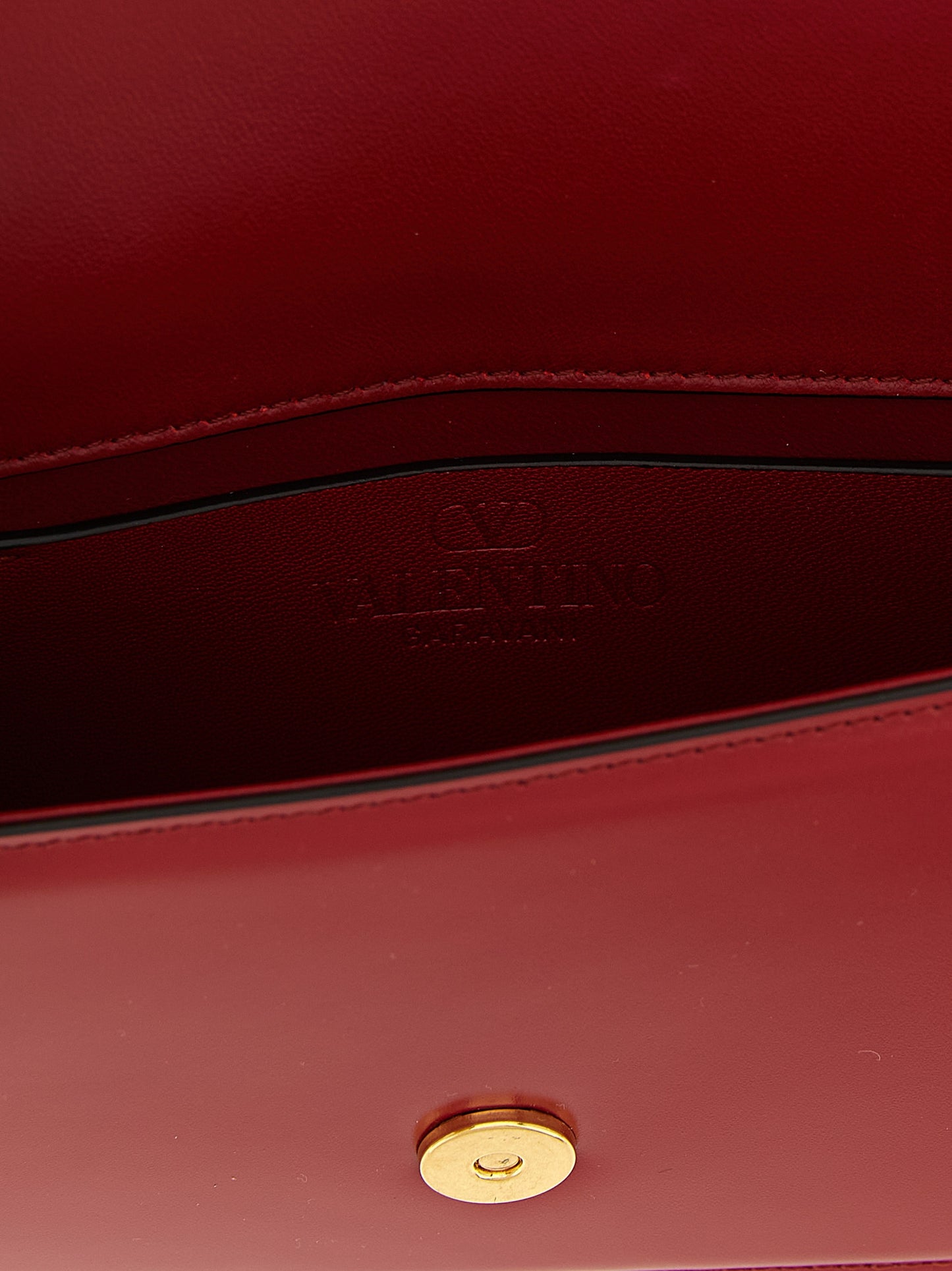 Evening Flap Clutch Handbag by Valentino Garavani for women in calfskin leather multicolor, red & signature features a statuesque silhouette, showcasing a secure flap & magnetic and organized with versatile shoulder-strap, adjustable-strap & detachable-strap for statuesque evening wear.