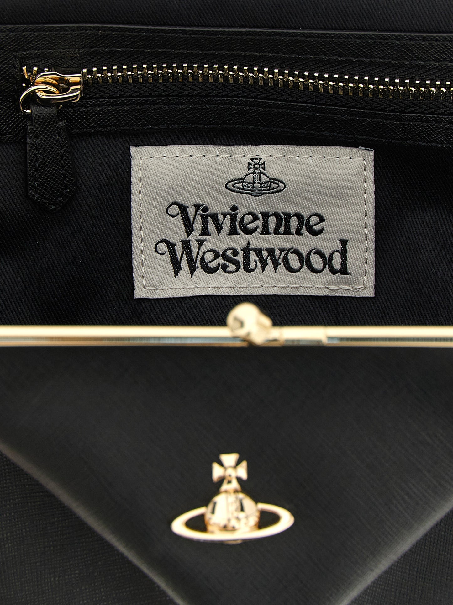 Frame Handbag by Vivienne Westwood for women in cotton & saffiano leather black features a contemporary silhouette, showcasing a secure snap, ample , and contemporary shoulder-strap, handle & detachable-strap for a sophisticated look.
