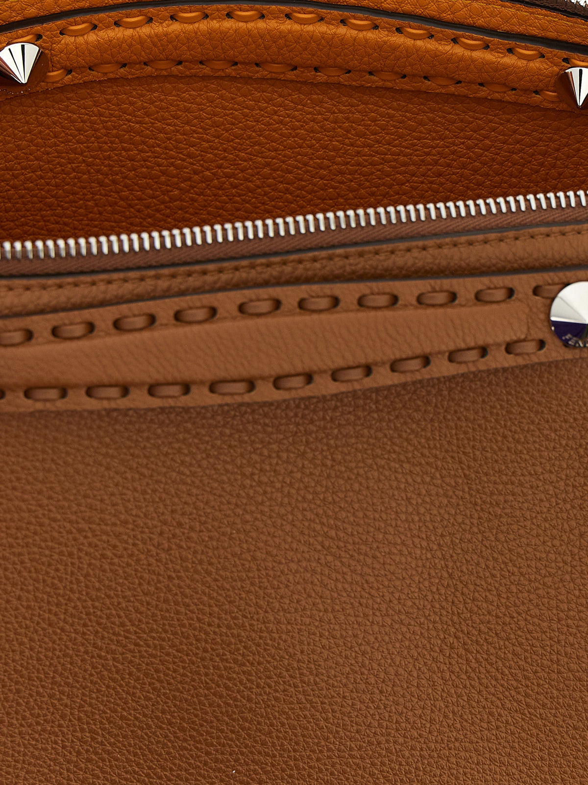 Medium Handbag by Fendi for women in calfskin leather brown & signature features a contemporary silhouette, showcasing a secure zipper, ample , and contemporary shoulder-strap, handle, adjustable-strap & detachable-strap for a sophisticated look.