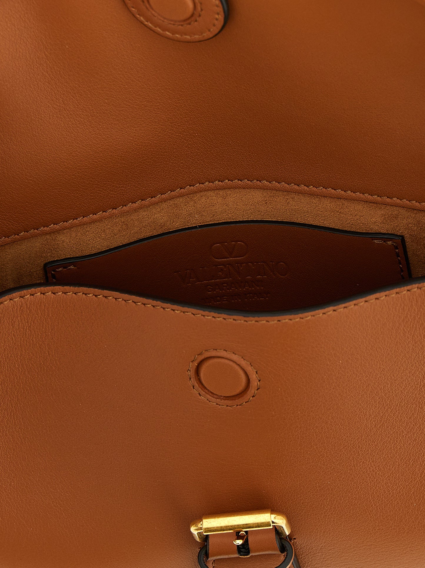 Small Shoulder Flap Bag by Valentino Garavani for women in calfskin leather brown & signature showcases a enviable silhouette, artfully detailed with a secure flap & magnetic, organized , and versatile shoulder-strap & adjustable-strap for a enviable look.
