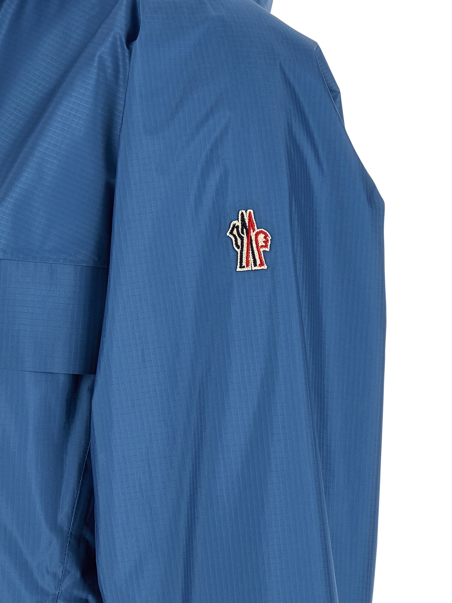 Hooded Windbreaker Jacket by Moncler Grenoble for men in polyamide & polyester blue features an perennial silhouette with a refined and perennial hooded, insulated & windproof for a sophisticated weather-resistant look.