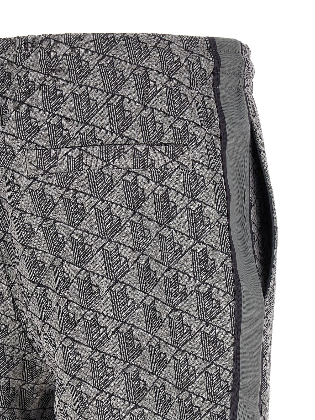 Joggers by Lacoste for men in polyamide polyester & cotton gray, patterned, jacquard & monogram presents a tailored silhouette, showcasing a tailored straight-leg and long cut with a refined for a truly tailored aesthetic.