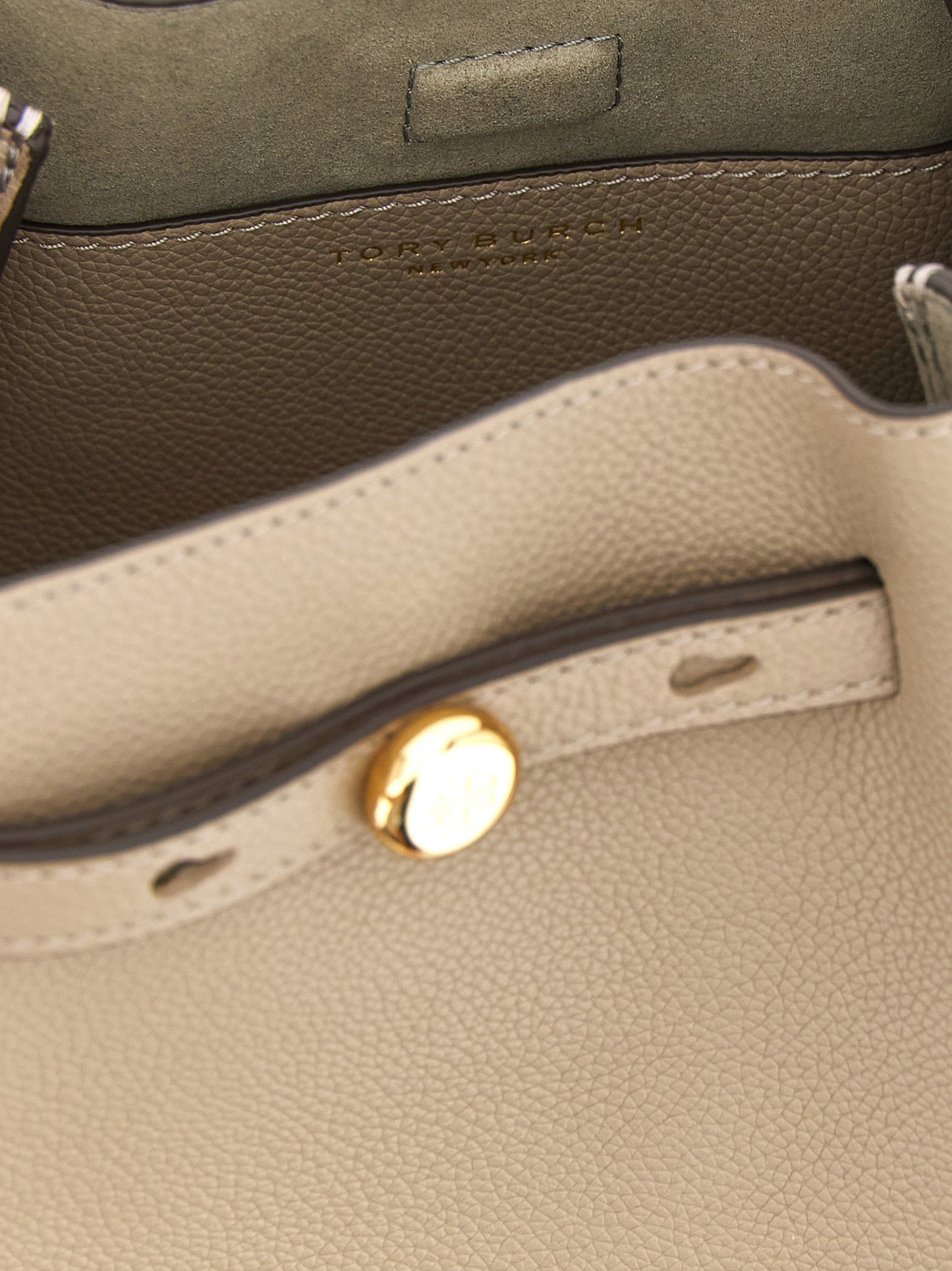 Bucket Handbag by Tory Burch for women in suede leather beige features an refined silhouette, showcasing a secure magnetic, ample , and versatile shoulder-strap, handle, adjustable-strap & belt-strap for a sophisticated refined aesthetic.