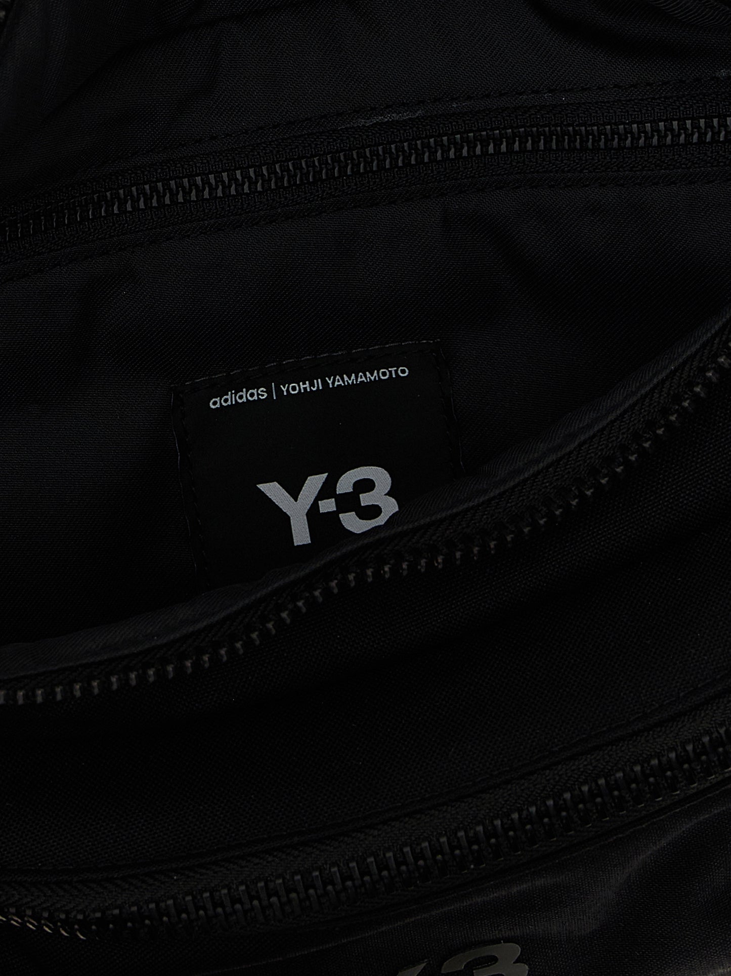 Crossbody Fanny Pack Handbag by Y-3 for unisex in polyamide black features a transformative sophistication silhouette, showcasing a secure zipper, ample , and versatile crossbody-strap, shoulder-strap & adjustable-strap for a transformative sophistication look.