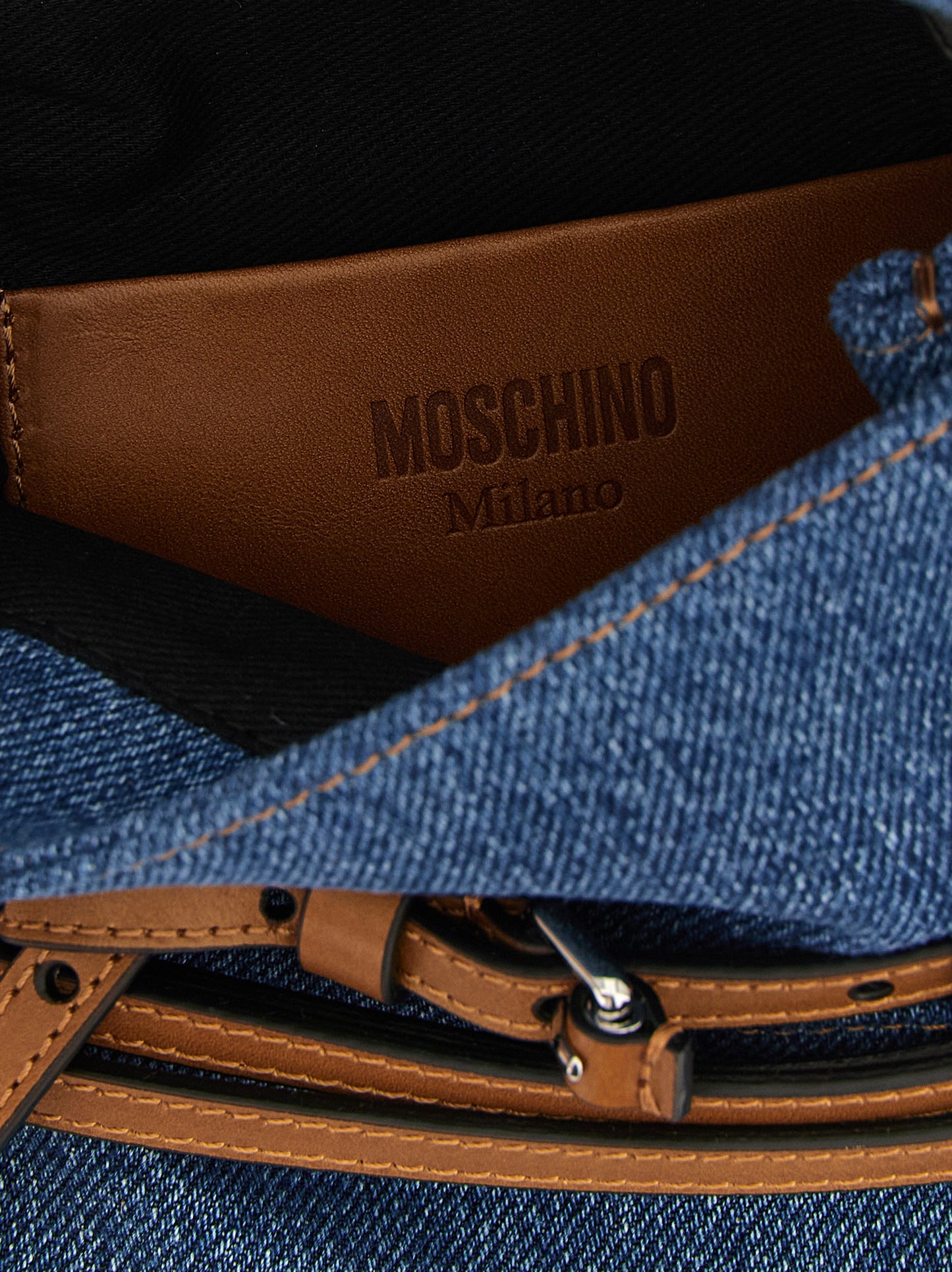 Small Handbag by Moschino for women in calf leather & cotton blue & brown presents a ornamental silhouette, showcasing a secure , ample , and versatile shoulder-strap, handle & adjustable-strap for a ornamental finish.