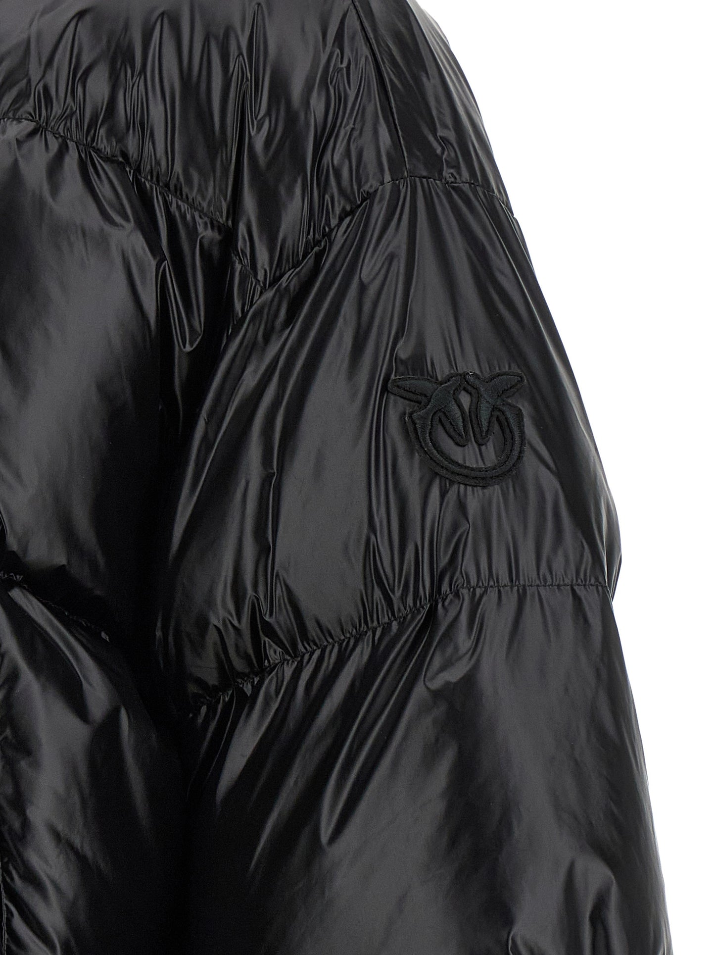 This Hooded Puffer Jacket by PINKO for women in polyamide black exhibits a edgy silhouette, meticulously detailed with functional hooded, insulated & windproof and a edgy for a edgy finish.