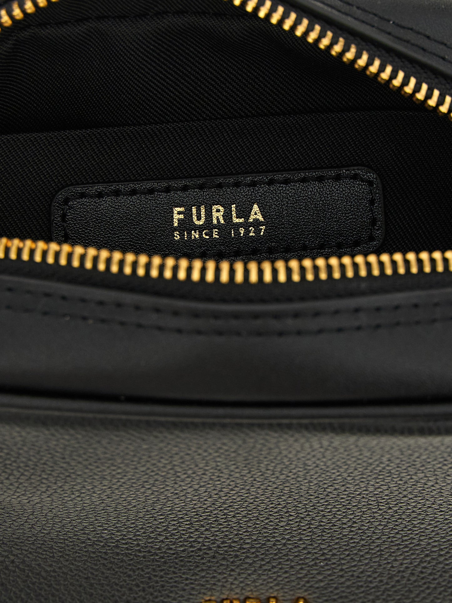 Compact Handbag by Furla for women in bos taurus calf suede leather black & gold presents a ornamental silhouette, showcasing a secure zipper, ample , and versatile shoulder-strap, adjustable-strap & handle for a ornamental finish.