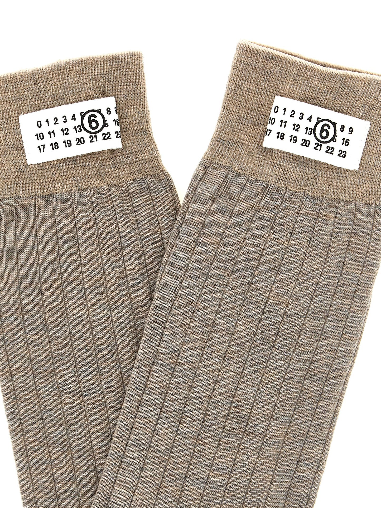 These Socks by MM6 Maison Margiela for women in polyamide wool beige & signature present a utilitarian silhouette from the Women's Polyamide Wool Socks collection, offering a utilitarian fit and refined aesthetic.