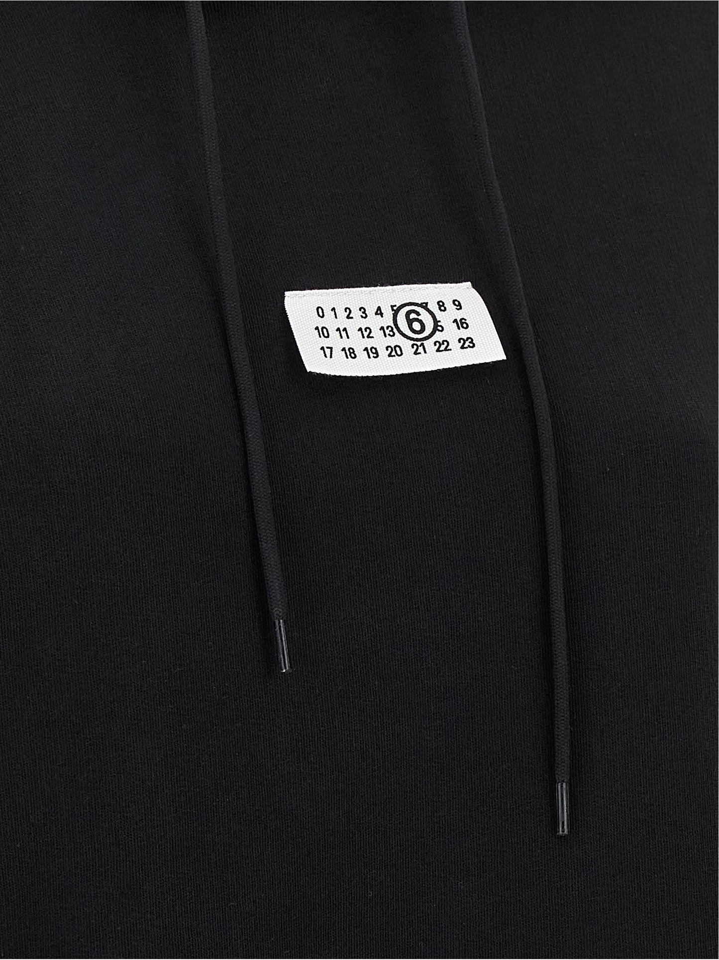 Sweatshirt Hoodie by MM6 Maison Margiela for women in cotton black, white & signature features an avant-garde silhouette, showcasing a sophisticated and detail for a truly avant-garde finish.