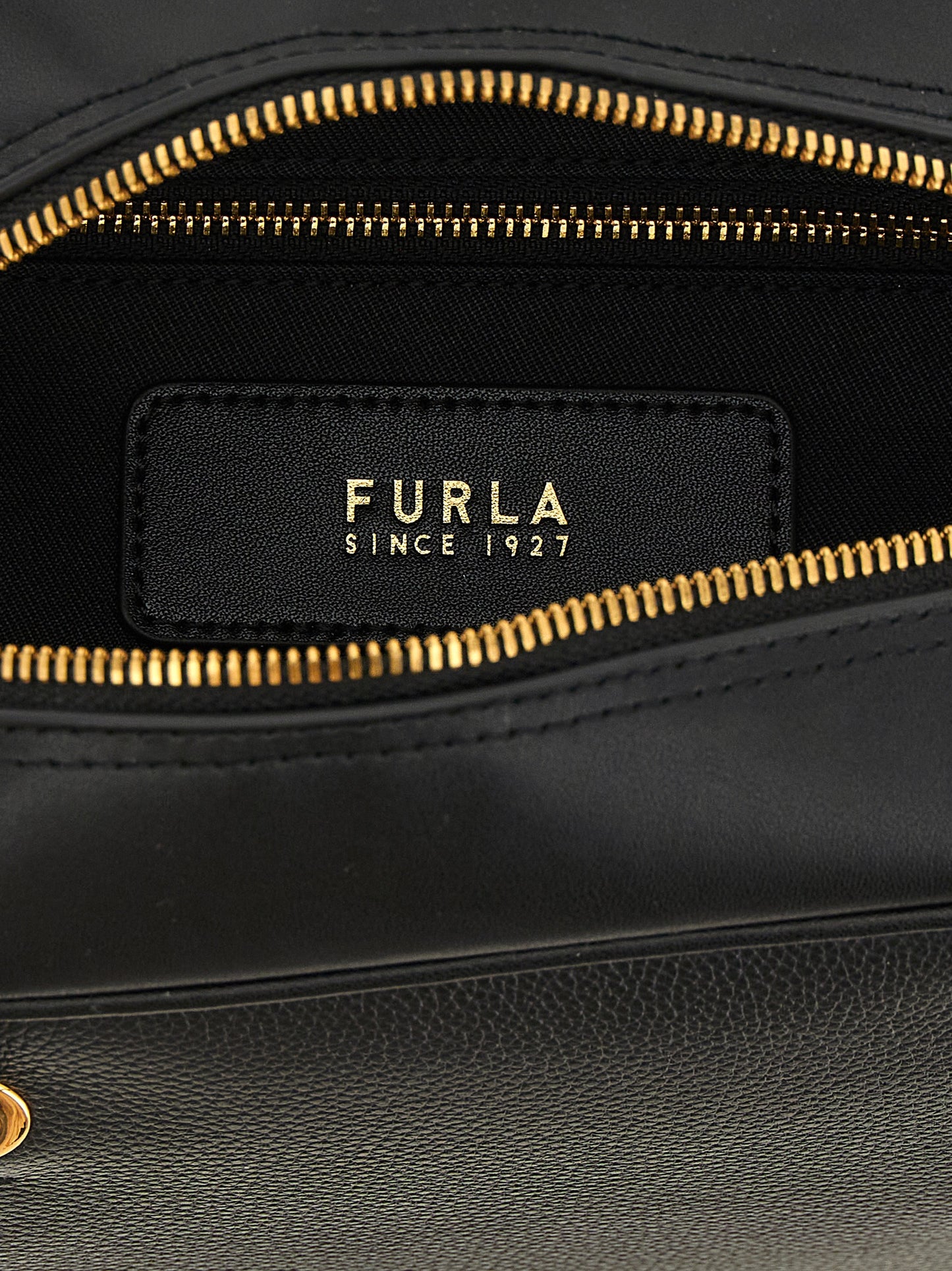 This Dome Handbag by Furla for women in calfskin leather and black & gold presents a sculptural silhouette featuring a secure zipper, ample , and versatile handle for a sculptural finish.