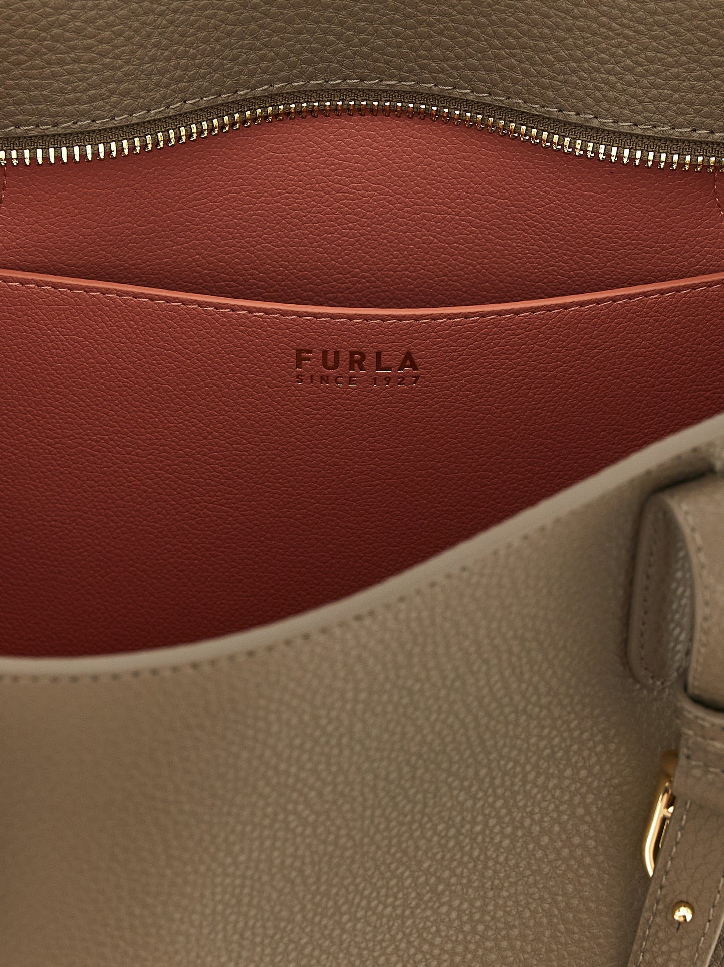 Tote Bag by Furla for women in bos taurus calfskin leather gray, gold & signature features a jet-set Ava Bos Taurus Calfskin Leather Tote Bag design, complete with a secure buckle, ample , and versatile adjustable-strap & handle for a jet-set look.