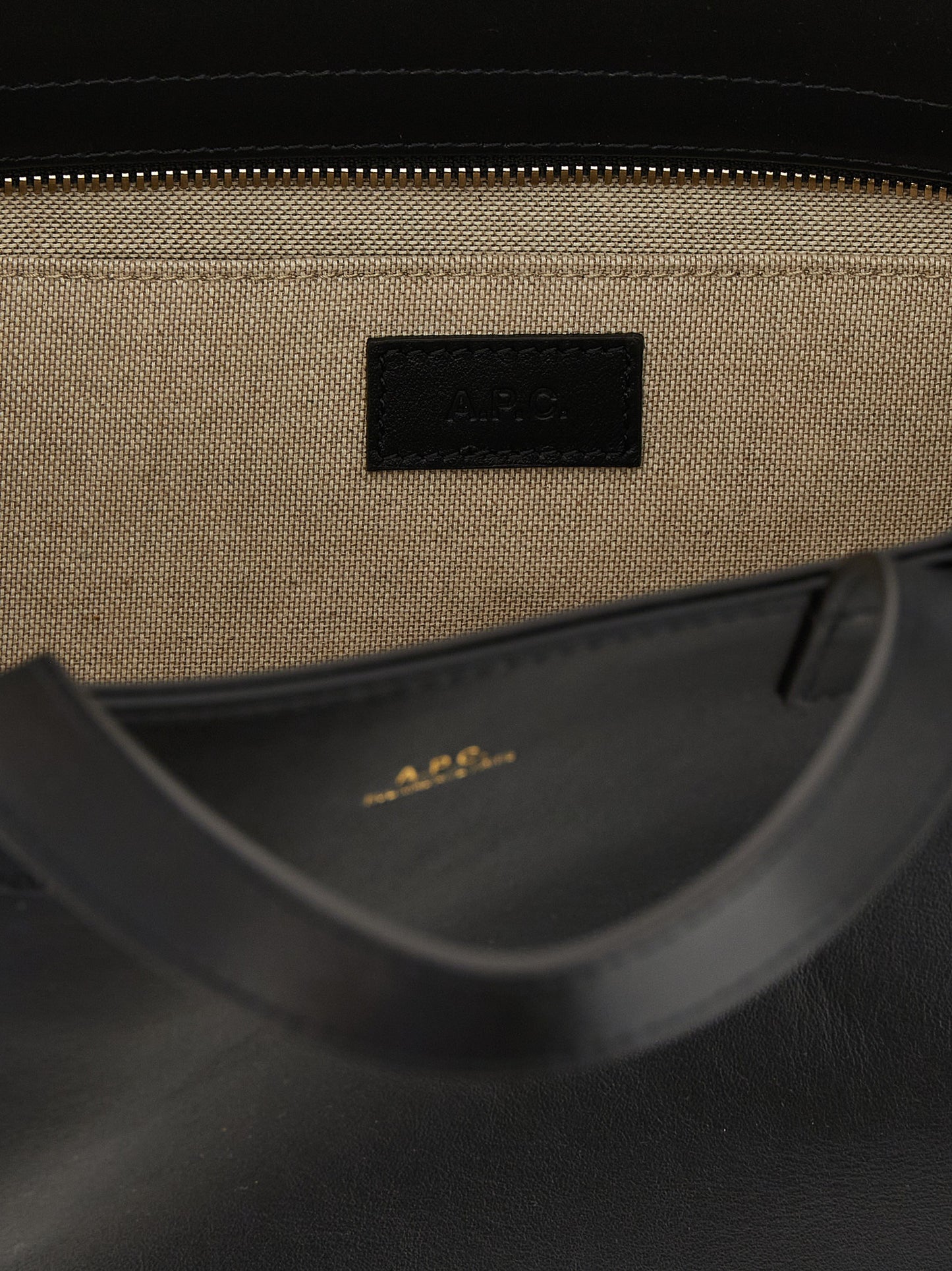 Small Shopper Tote Clutch Bag by A.P.C. for women in cotton polyester canvas black & gold features an jet-set-ready silhouette, showcasing the Le Drummer Cotton Polyester Canvas Small Shopper Tote Clutch Bag design with a secure zipper, ample , and versatile handle.