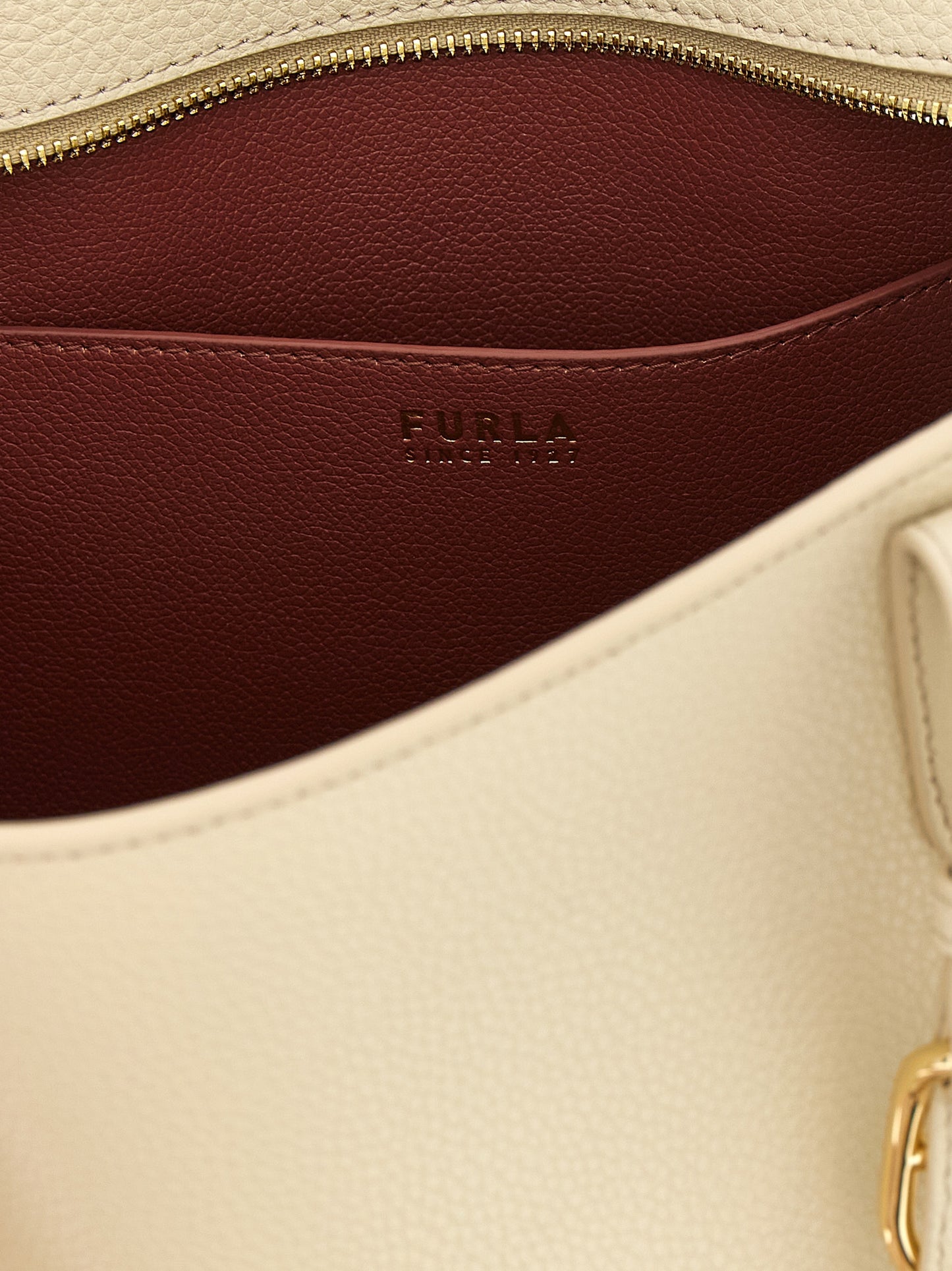 Pouch Tote Bag by Furla for women in calfskin leather burgundy, cream, gold & white showcases a statuesque 1927 Ava Calfskin Leather Pouch Tote Bag design, featuring a secure zipper & buckle, ample , and versatile handle & adjustable-strap for a statuesque finish.