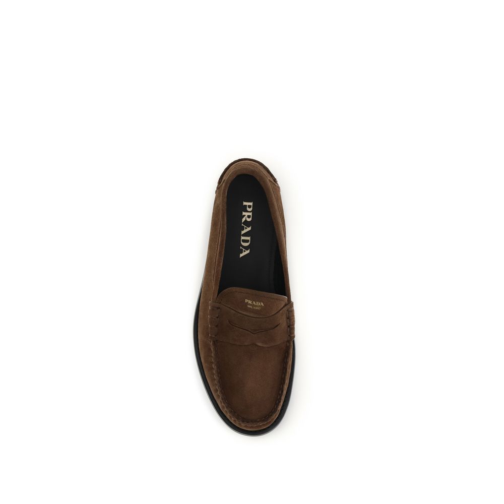 Loafer Slip-On Strap Shoes by Prada for men in bos taurus calf suede leather brown features an dynamic silhouette from the Men's Bos Taurus Calf Suede Leather Loafer Slip-On Strap Shoes collection, defined by a dynamic and for a dynamic look.