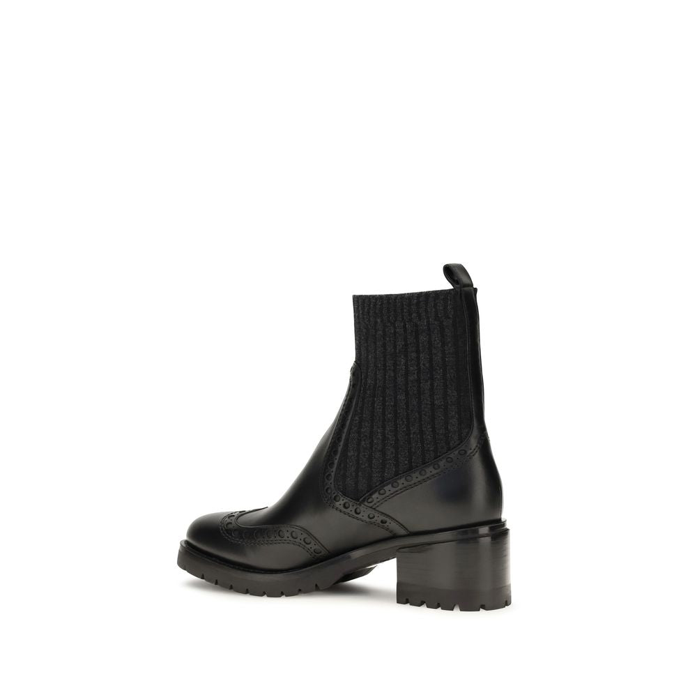 Ankle Cut-Out Boots by Santoni for women in bos taurus calfskin leather black features an dynamic silhouette, showcasing the dynamic Women's Bos Taurus Calfskin Leather Ankle Cut-Out Boots design with its distinctive and elegant .