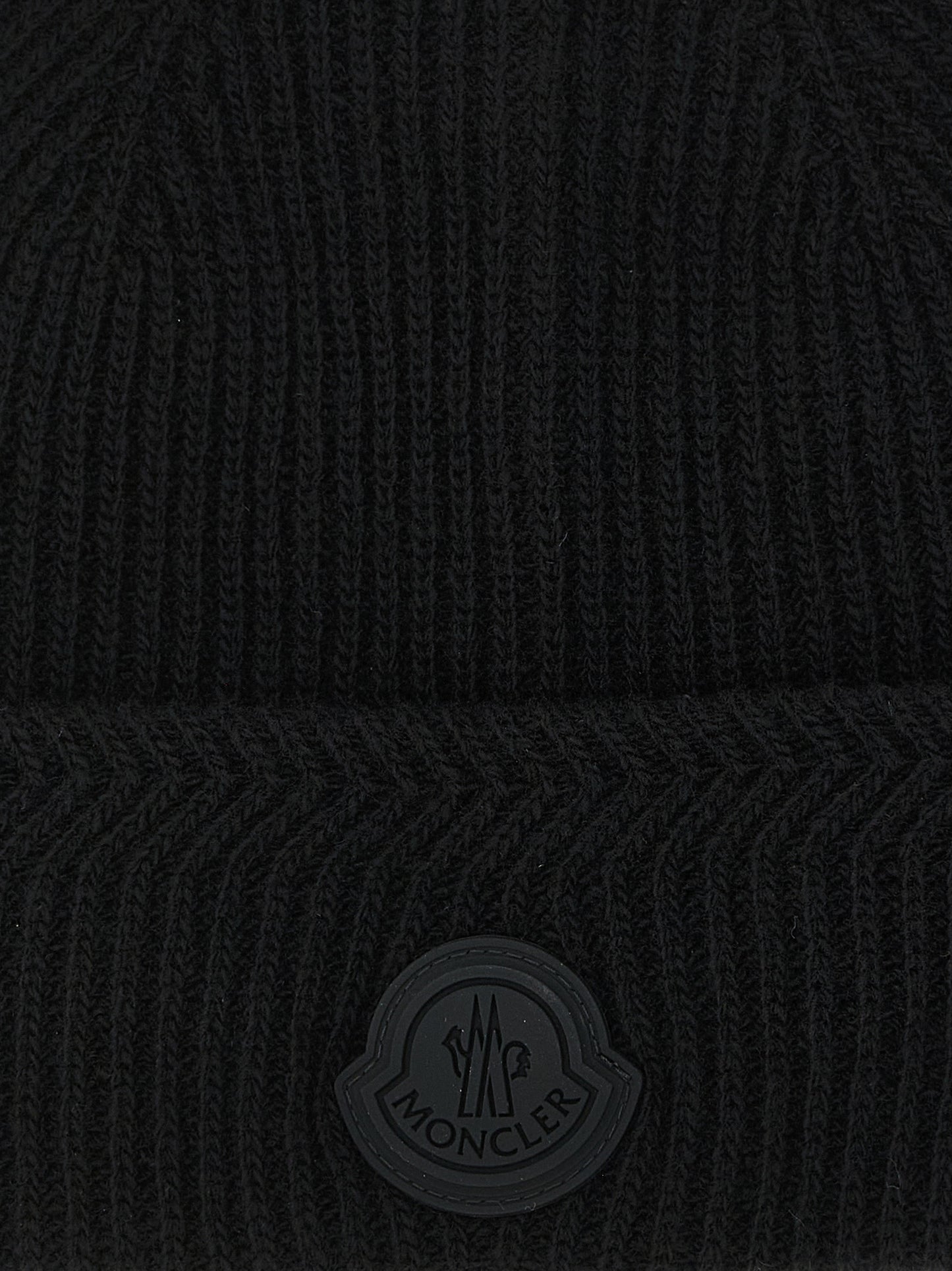 Beanie Hat by Moncler for men in cashmere virgin wool black, patterned & herringbone presents a sleek silhouette, showcasing the sleek texture and refined craftsmanship of the Cashmere Virgin Wool Beanie Hat collection.