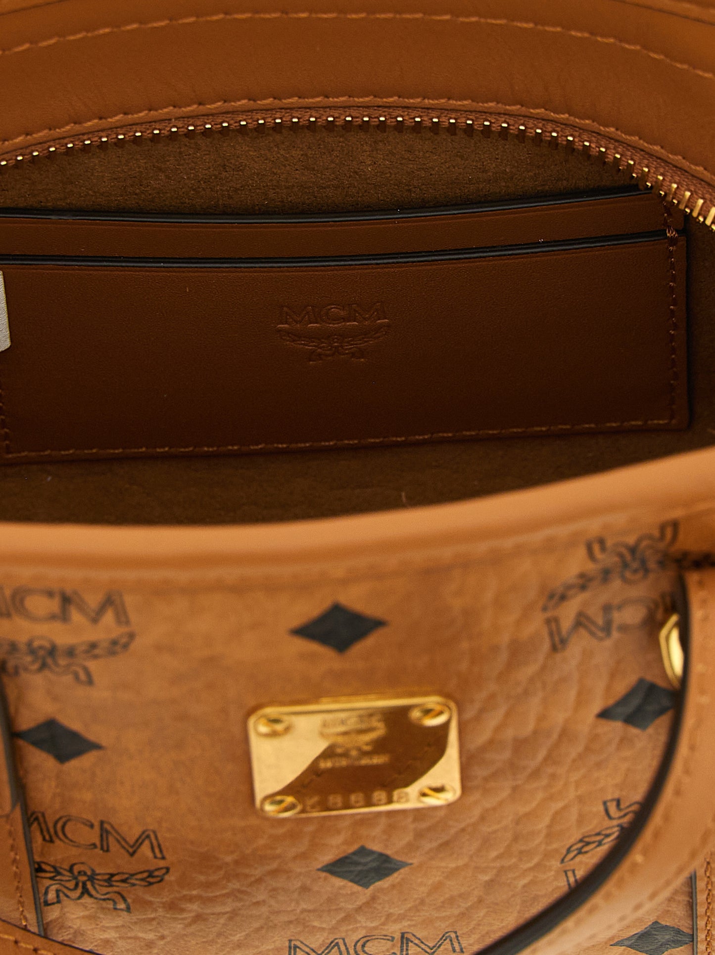 Mini Shopper Tote Bag by MCM for women in cotton canvas poly leather brown, gold, natural & monogram features a distinguished Visetos Cotton Canvas Poly Leather Mini Shopper Tote Bag design, complete with a secure , ample , and versatile shoulder-strap & handle for a distinguished look.