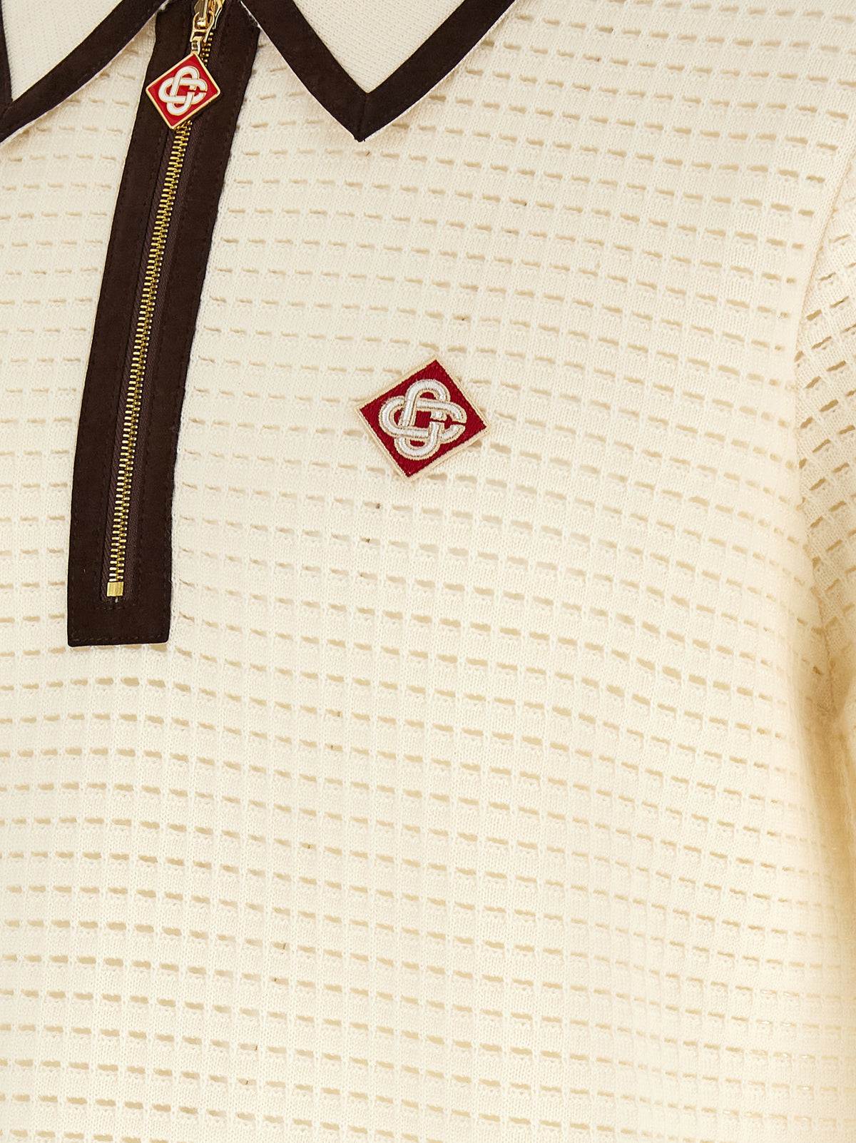 This Polo Shirt by Casablanca for men in wool brown, white, patterned & signature presents a flawless silhouette, showcasing flawless detailing and a refined for a truly flawless aesthetic.