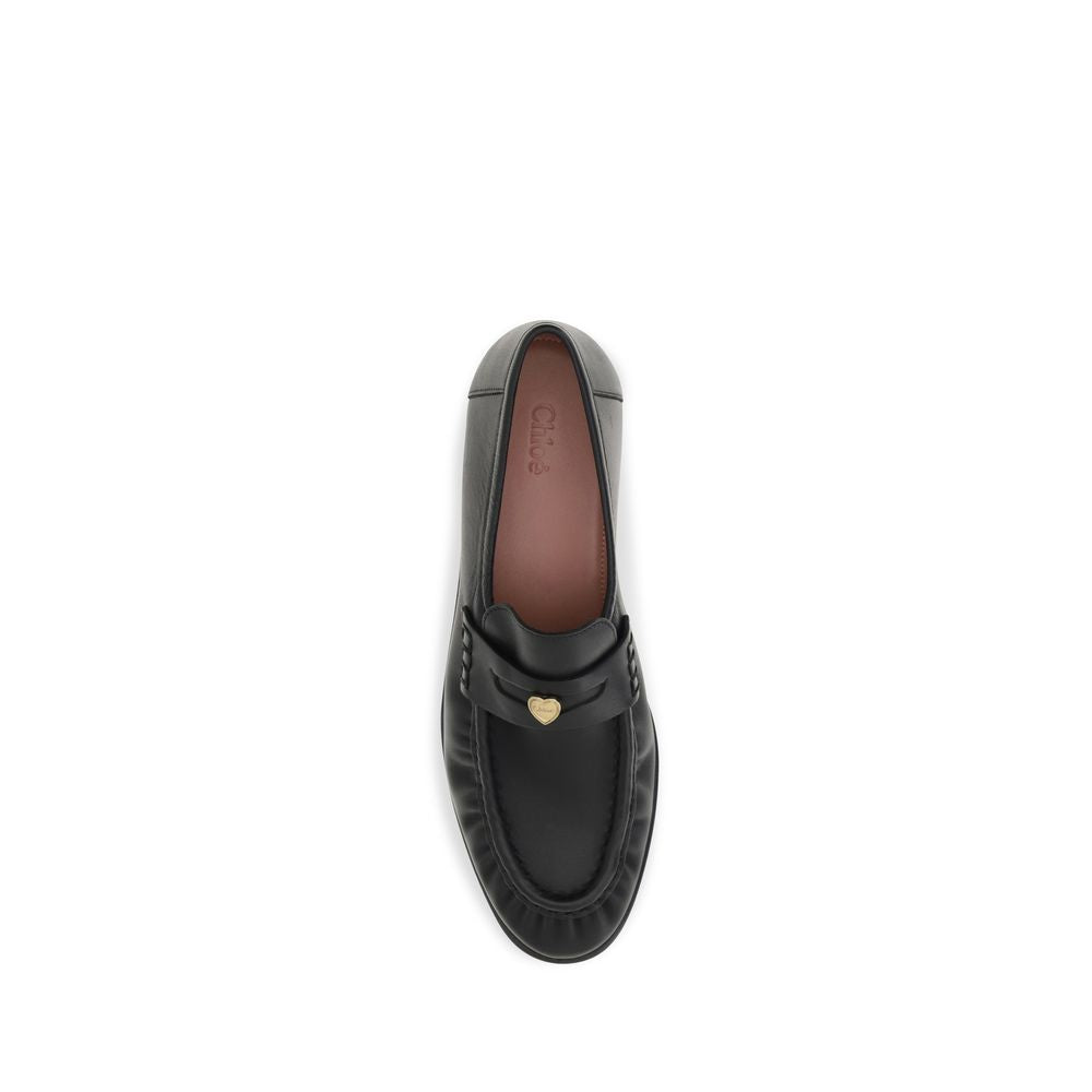 Flat Loafer Slip-On Strap Shoes by Chloé for women in bos taurus calf leather black & signature showcases a timeless silhouette from the Women's Bos Taurus Calf Leather Flat Loafer Slip-On Strap Shoes collection, featuring a timeless flat and for a timeless finish.