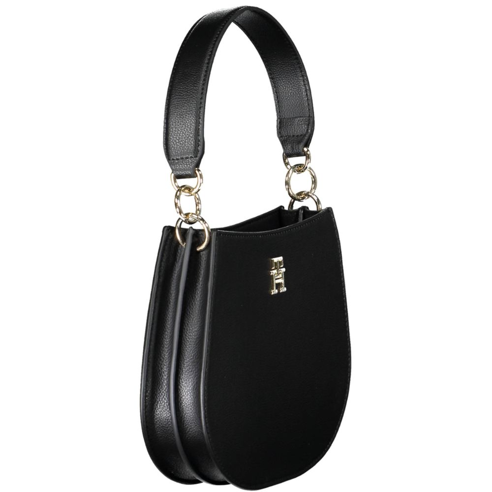 Crossbody Evening Convertible Handbag by Tommy Hilfiger for women in polyester polyethylene faux leather black features a polished silhouette with a secure zipper, ample built-in-compartments, and polished crossbody-strap, shoulder-strap, adjustable-strap & handle for a sophisticated look.