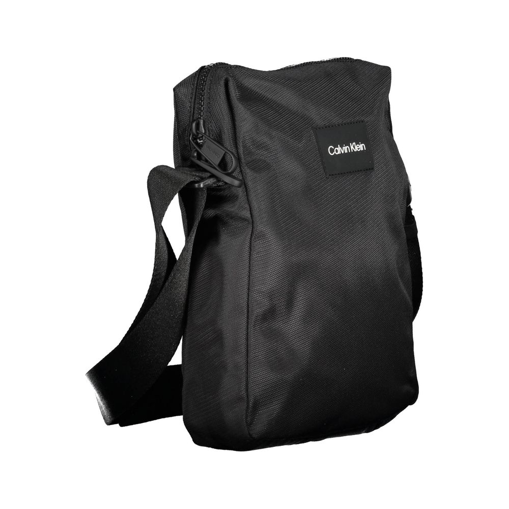 Shoulder Bag by Calvin Klein for men in polyester & polyethylene black presents a statuesque silhouette, showcasing a secure zipper and statuesque internal-pockets with versatile shoulder-strap & adjustable-strap for a sophisticated look.