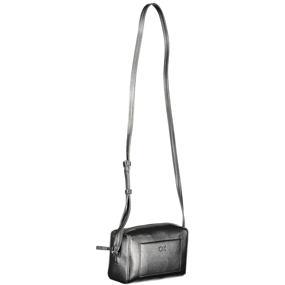 Crossbody Convertible Handbag by Calvin Klein for women in faux patent & pebbled leather black features an exquisite silhouette, showcasing a secure zipper, ample external-pockets & cardholder, and exquisite crossbody-strap & adjustable-strap for a sophisticated finish.