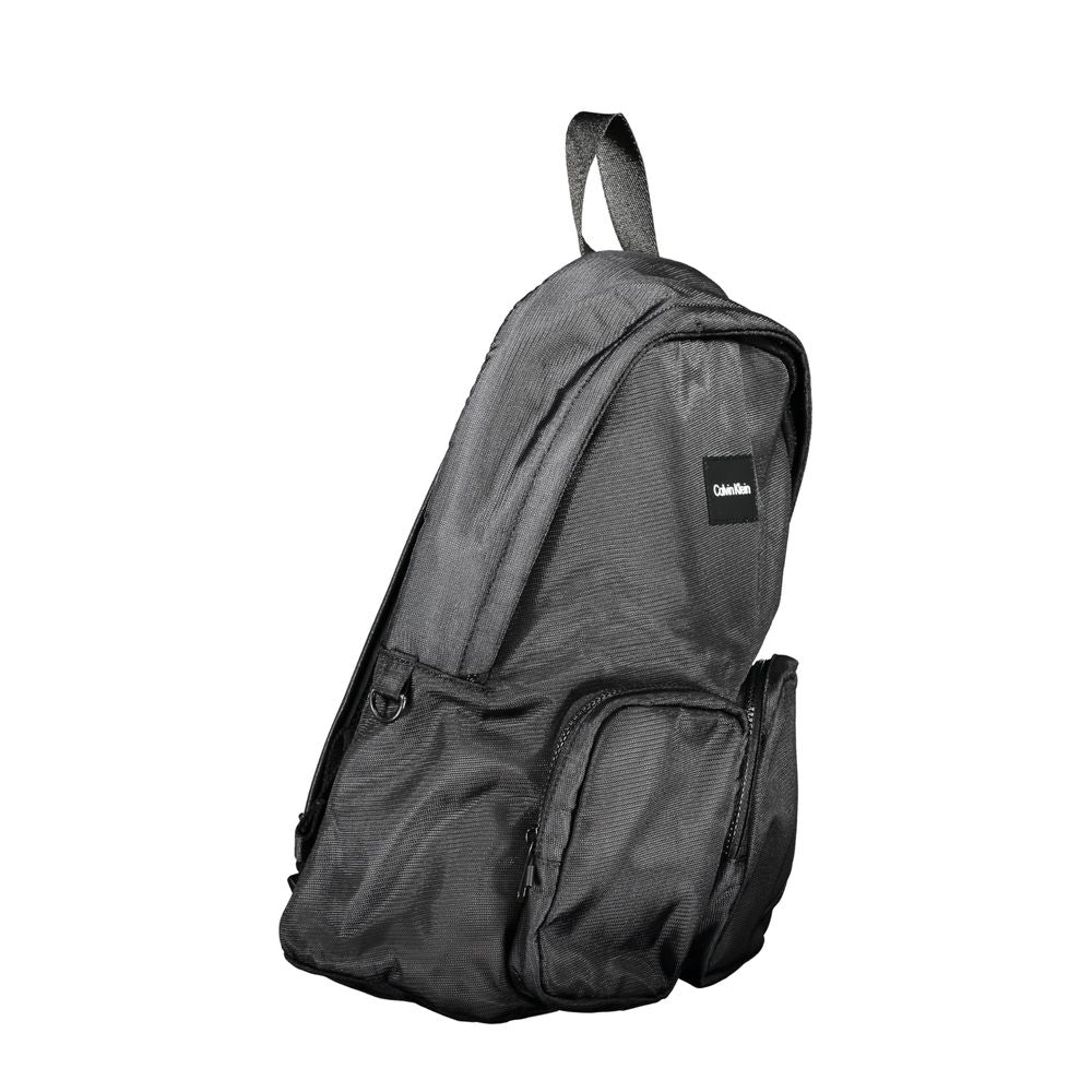 Backpack by Calvin Klein for men in polyester black features a architectural Polyester Backpack design with a secure zipper, ample external-pockets, internal-pockets & laptop-compartment, and versatile handle, backpack-strap & adjustable-strap for a architectural finish.